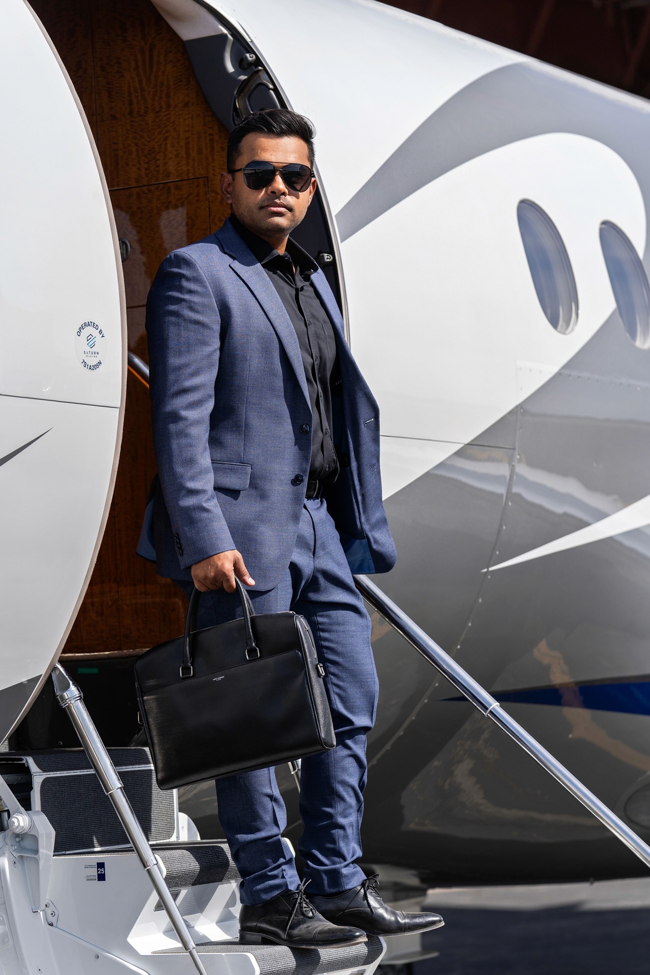 man exiting private jet with brief case