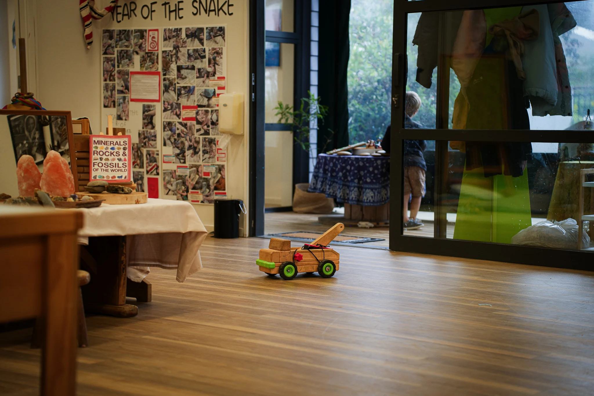 Young children engage in supervised water play with a teacher in an outdoor early childhood environment.