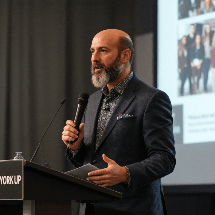 A man giving a presentation at a conference.