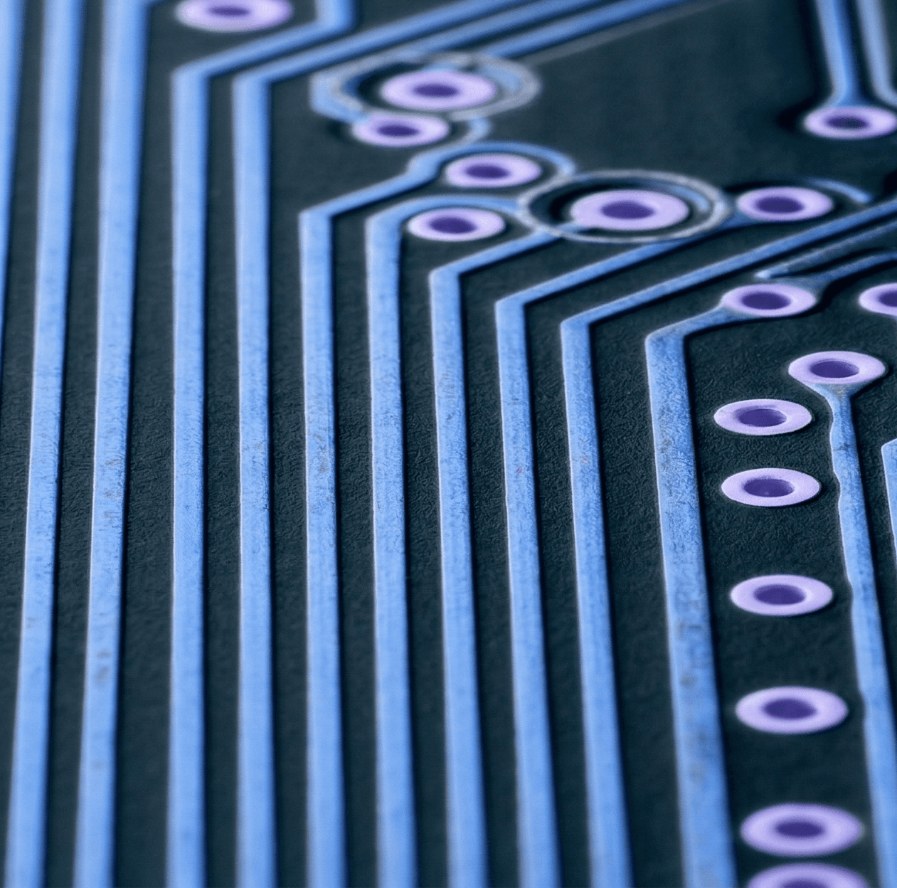 Aerial view of a winding road surrounded by dense green and yellow trees, showcasing nature’s vibrant colors.