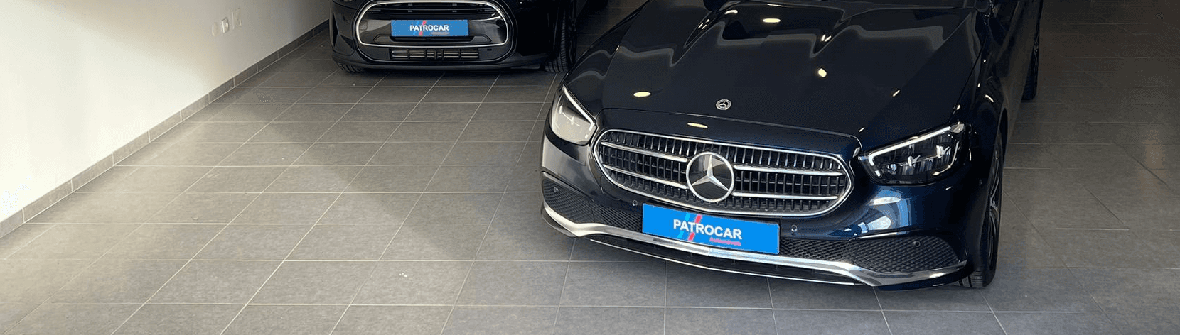 Two cheerful men laughing in the front seats of a sportscar, great for car rental joy promotions.