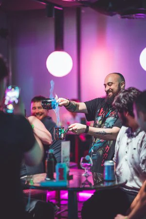 A cocktail performance on display with people watching on 