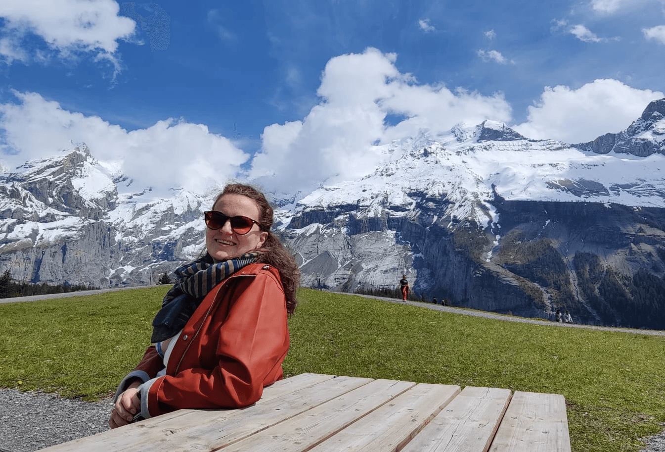 Stephanie sitting at a picnic table in the Swiss Alps