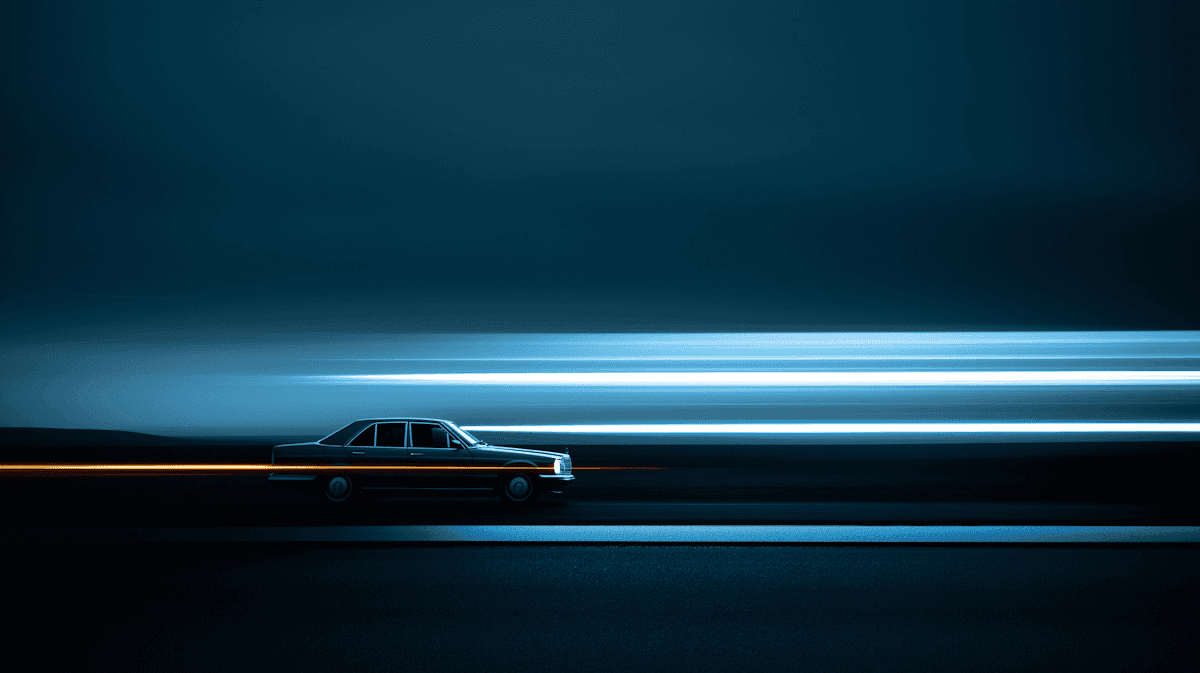 A car drives on a dark road at night, leaving bright light trails behind it.