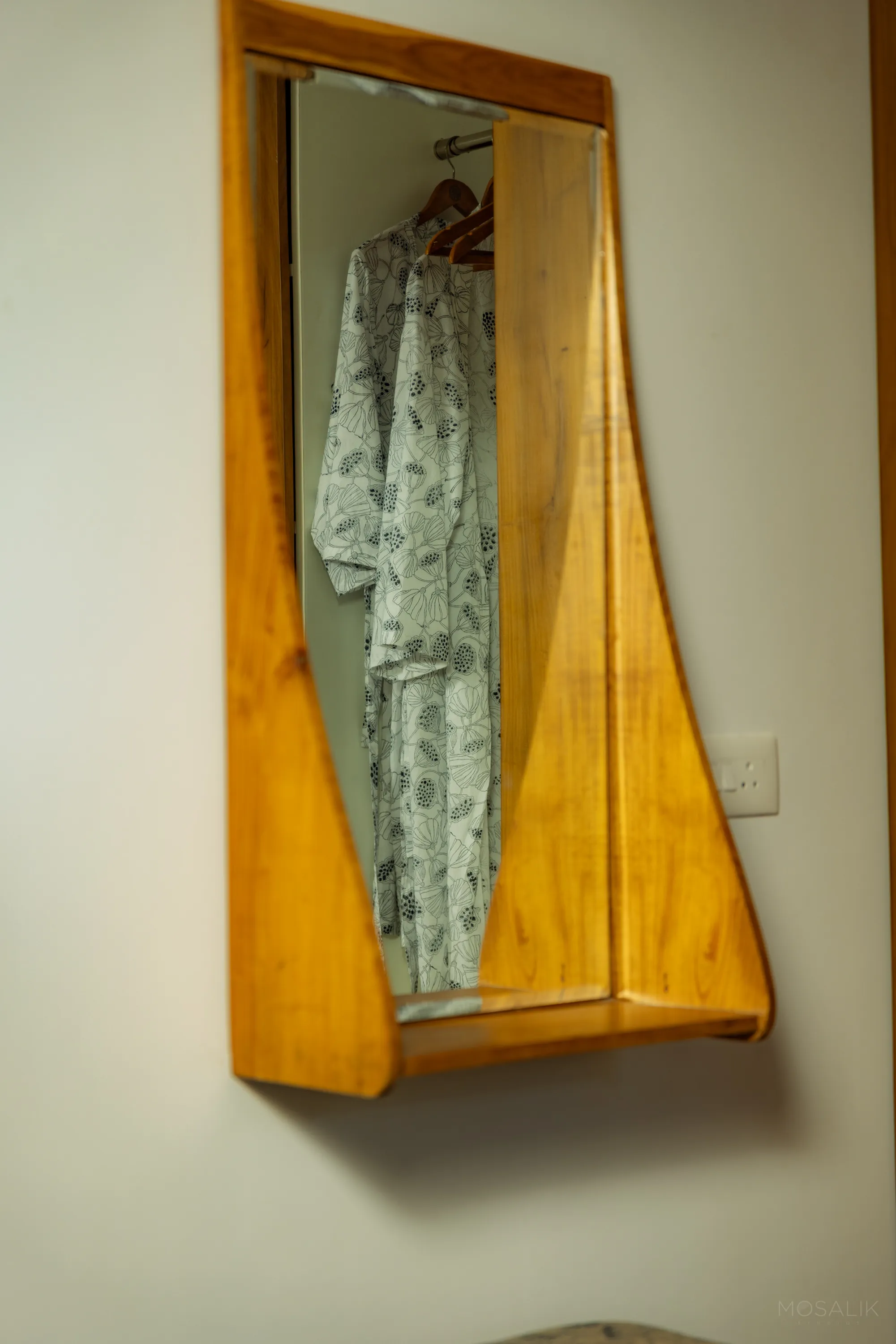 Handmade teak mirror in a Jaali Blue room