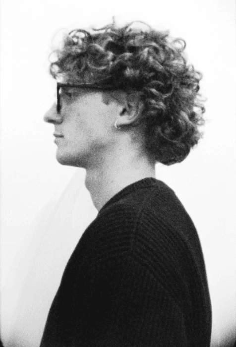 a blurry photo of a person standing in front of a wall