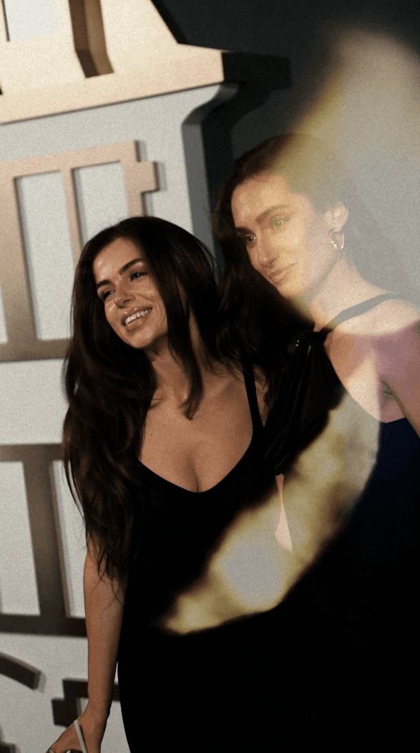 Woman hugging Shiba Inu dog, both looking at camera