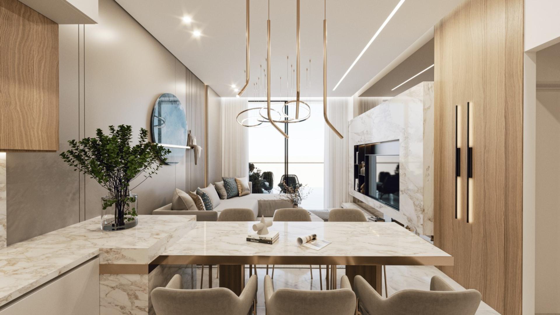  A sleek modern kitchen and dining area in a stylish apartment at Samana Miami, featuring contemporary design elements.
