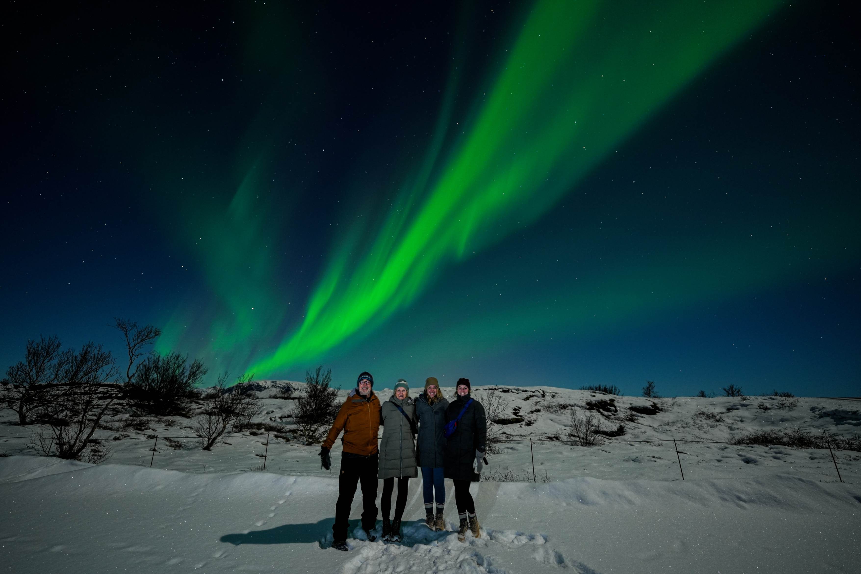 Northern Lights tour photography from Aurora Experts in Iceland, featuring guests beneath the aurora, winter landscapes, and vivid skies over remote Icelandic locations.