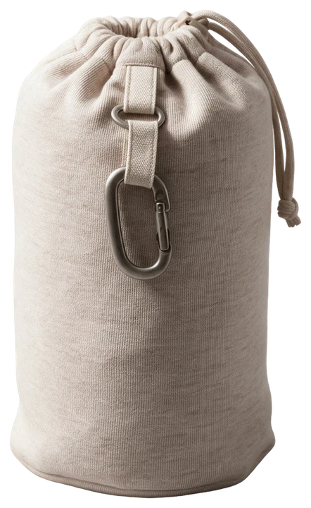The Cozzi pillow packed into its oat knit drawstring pouch with a metal clip