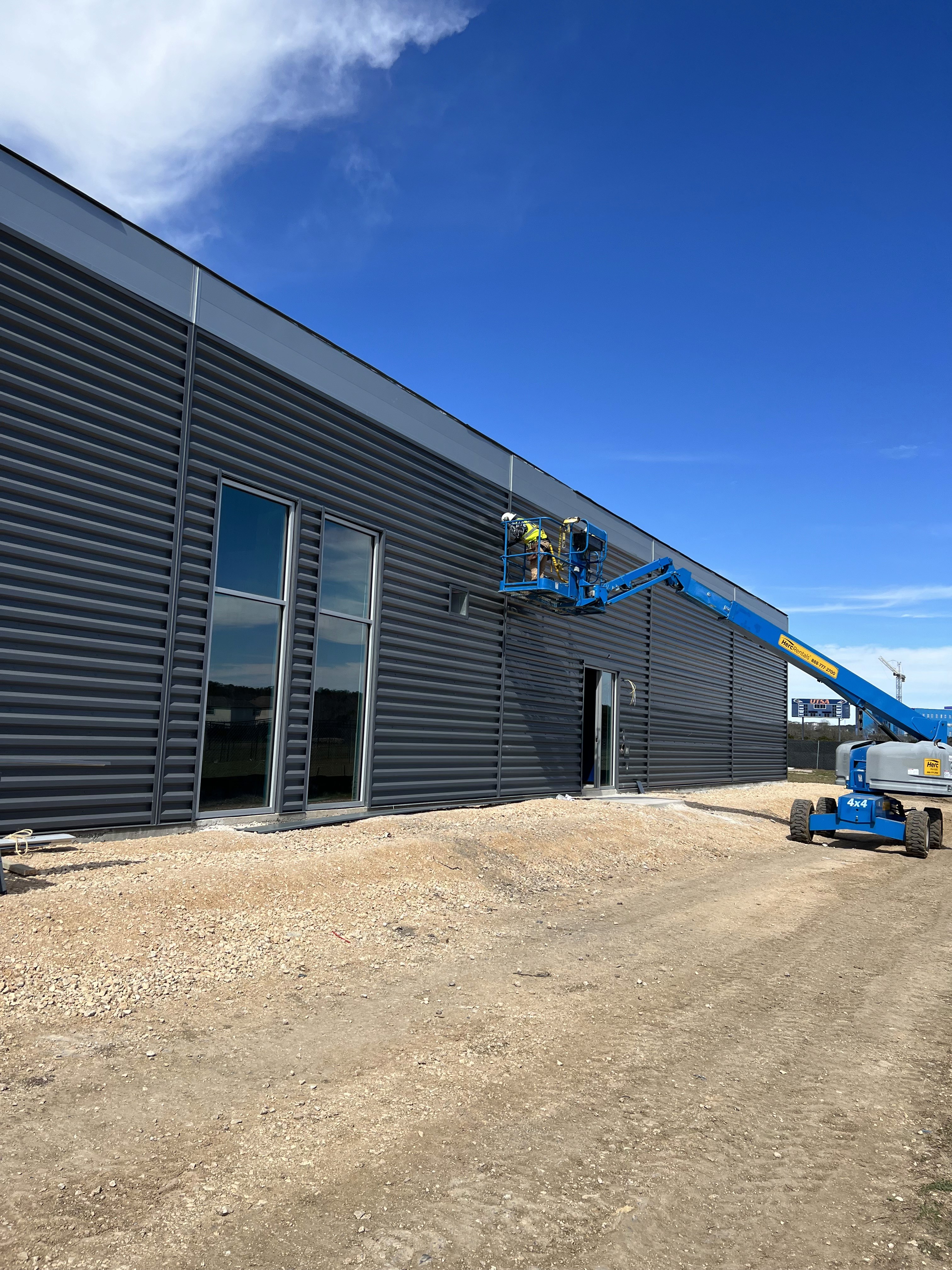 man working on side of building