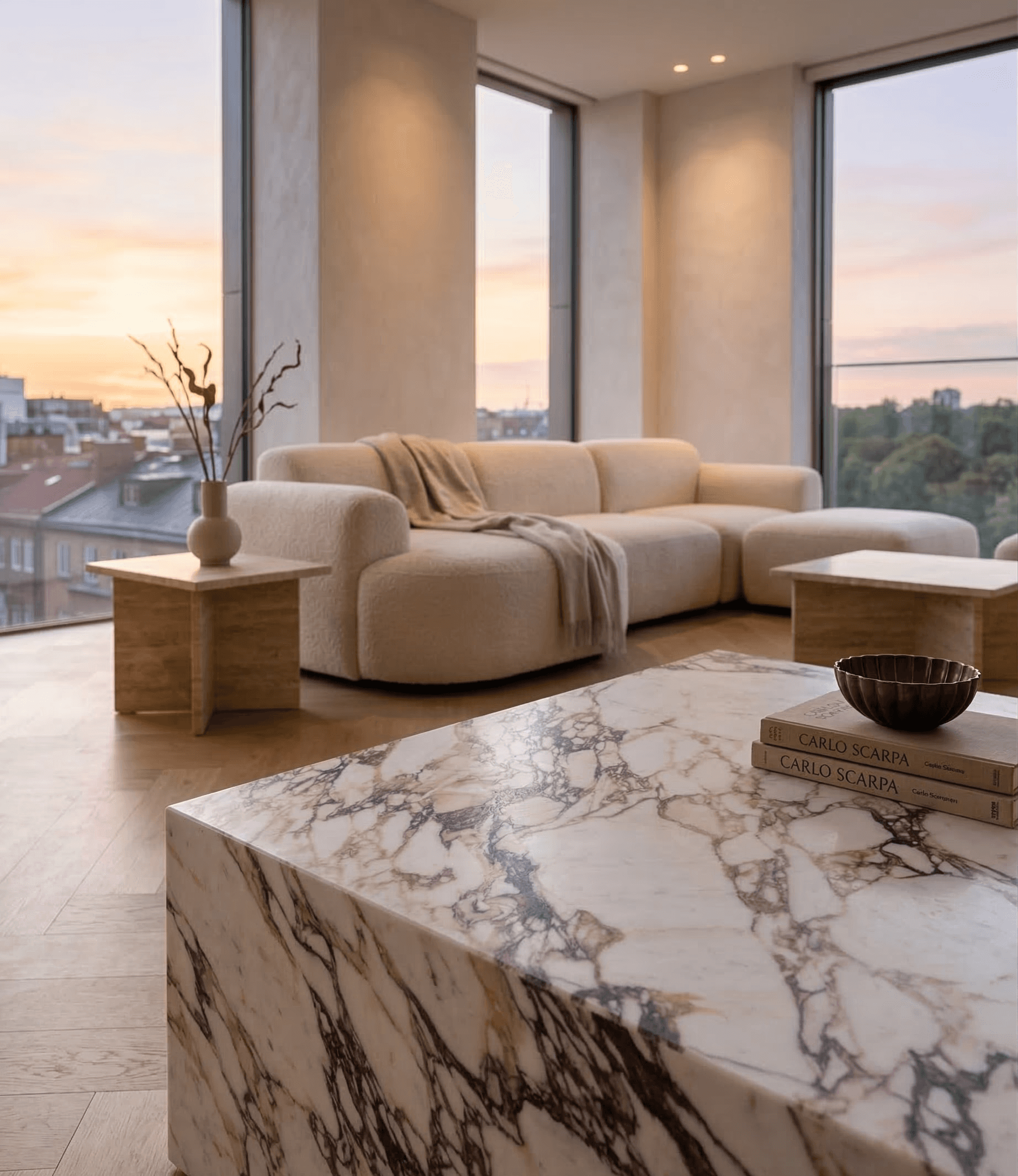 Rammed-earth space with curved walls, wooden seating, and soft daylight from a tall window.