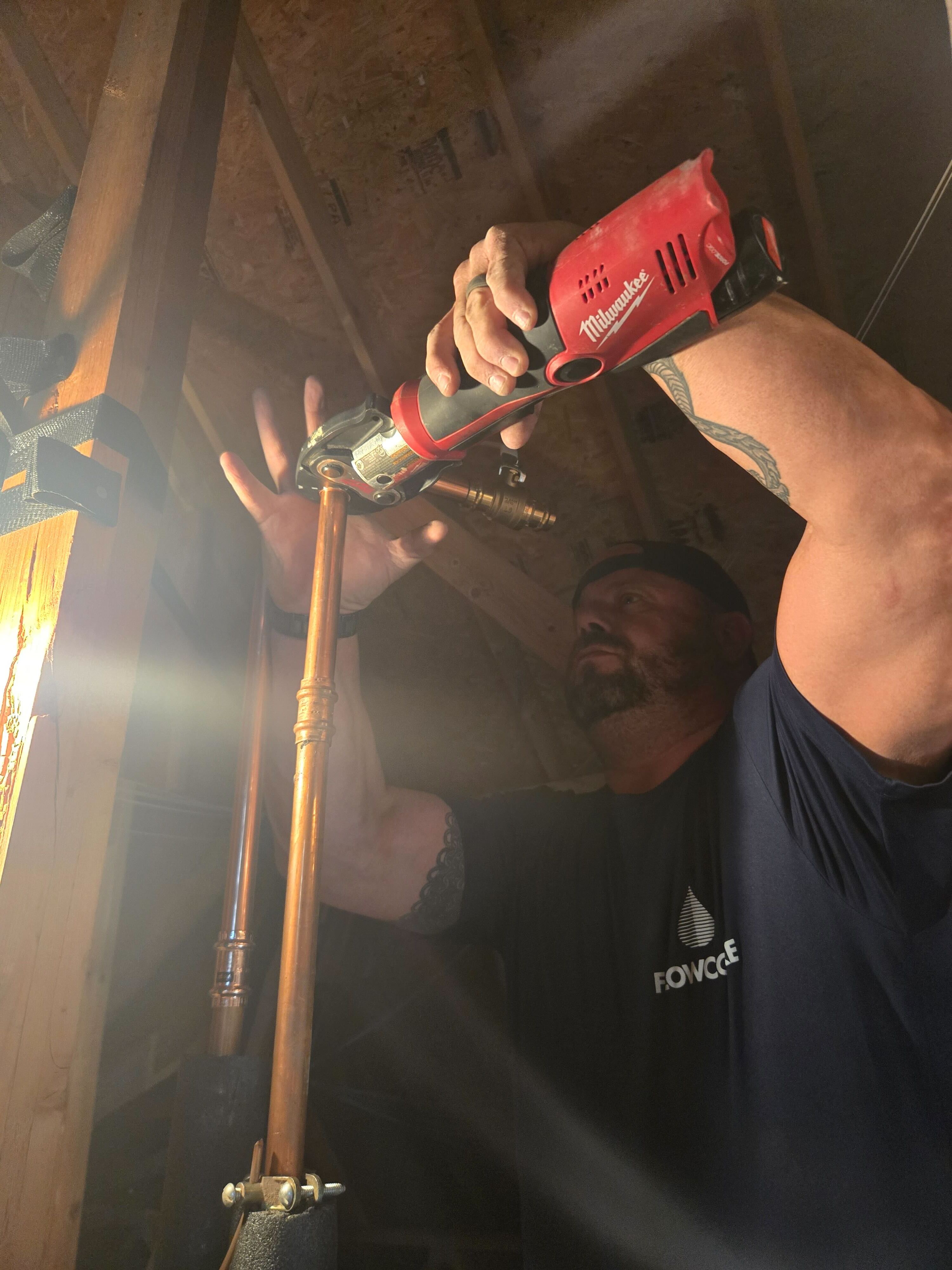 Flowcore Water plumber making copper line connections during a water heater installation in a Dallas-area home