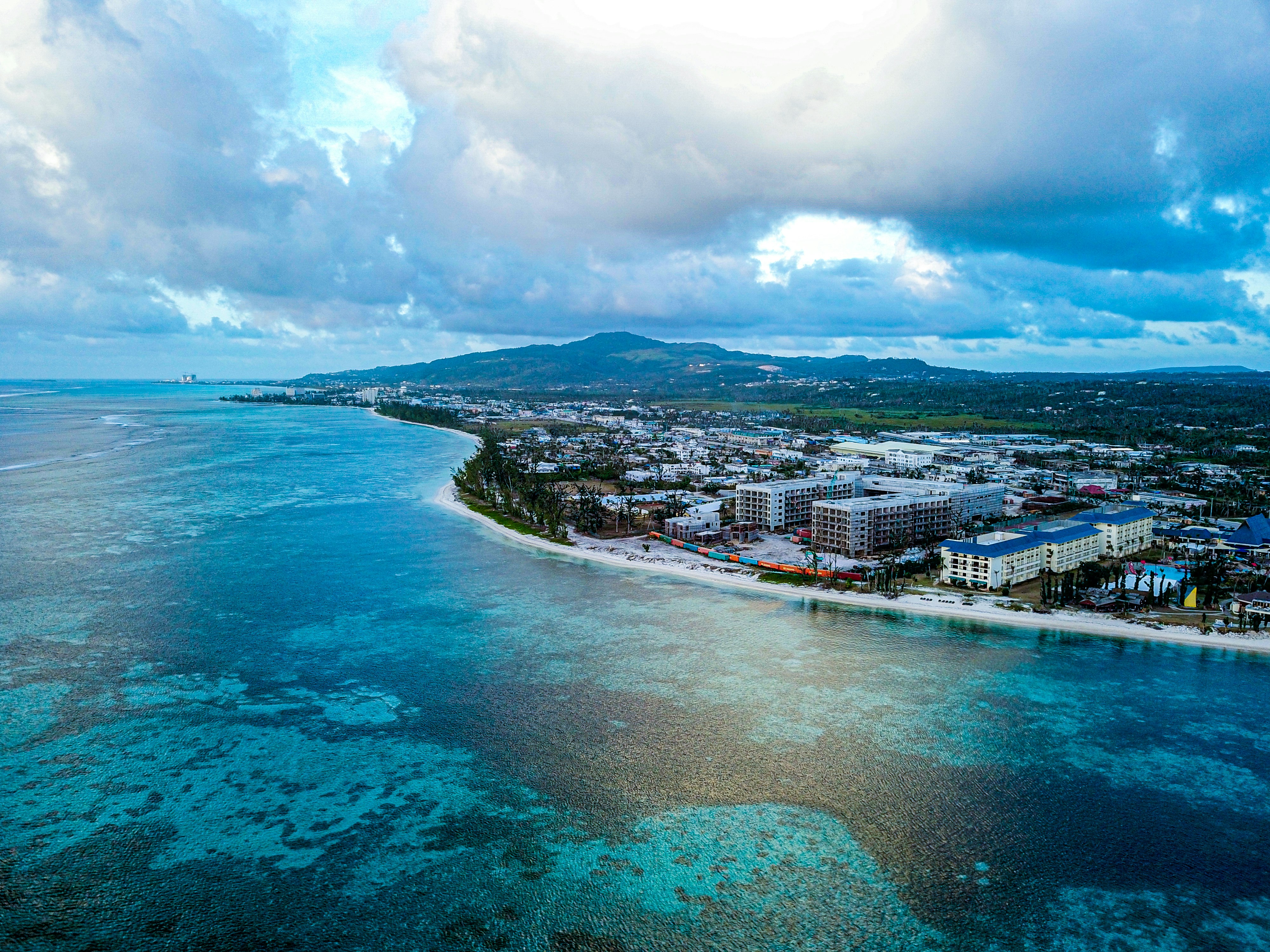 wide-angle photography of buildings beside seashore during daytime