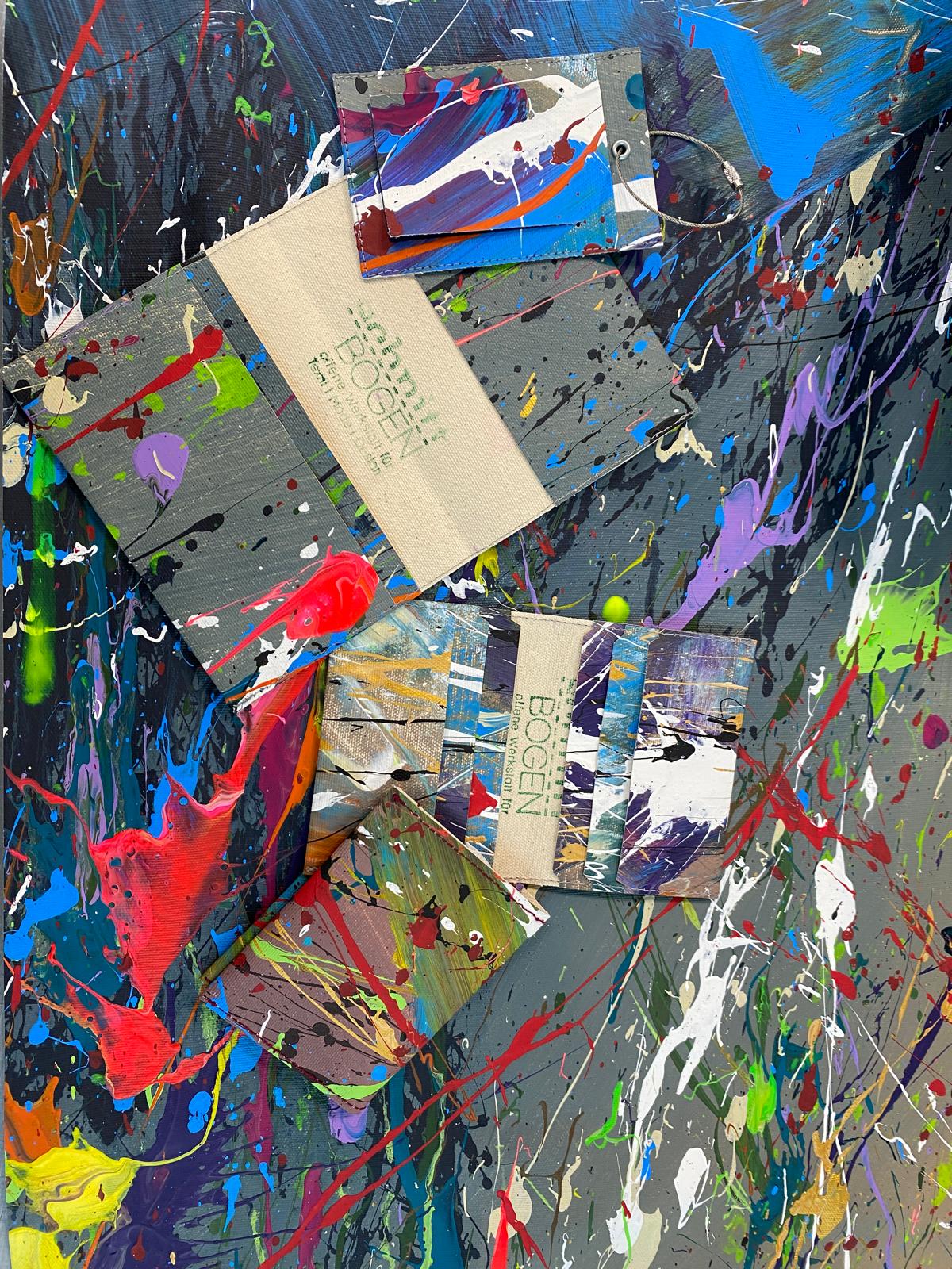 colourful wallet on splattered canvas background