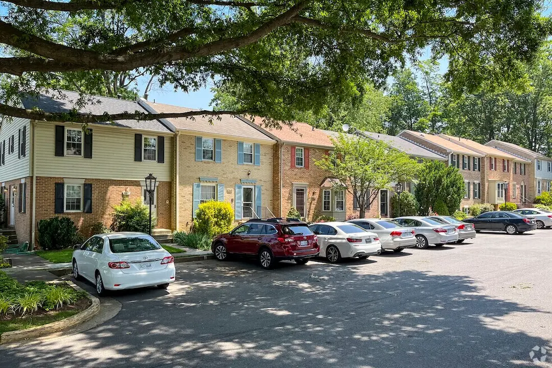 A row of residential brick townhomes in Merrifield, VA, serviced by a licensed local plumber.