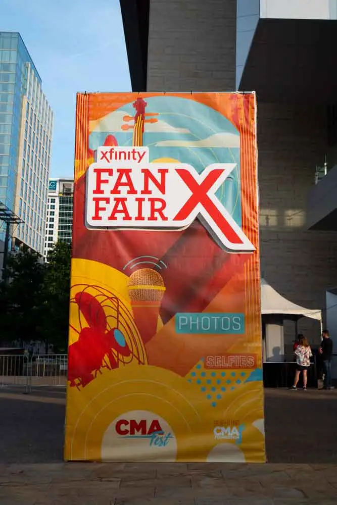 Colorful Xfinity Fan Fair X banner at CMA Fest 2018, promoting photo ops, selfies, and immersive fan interactions in downtown Nashville.