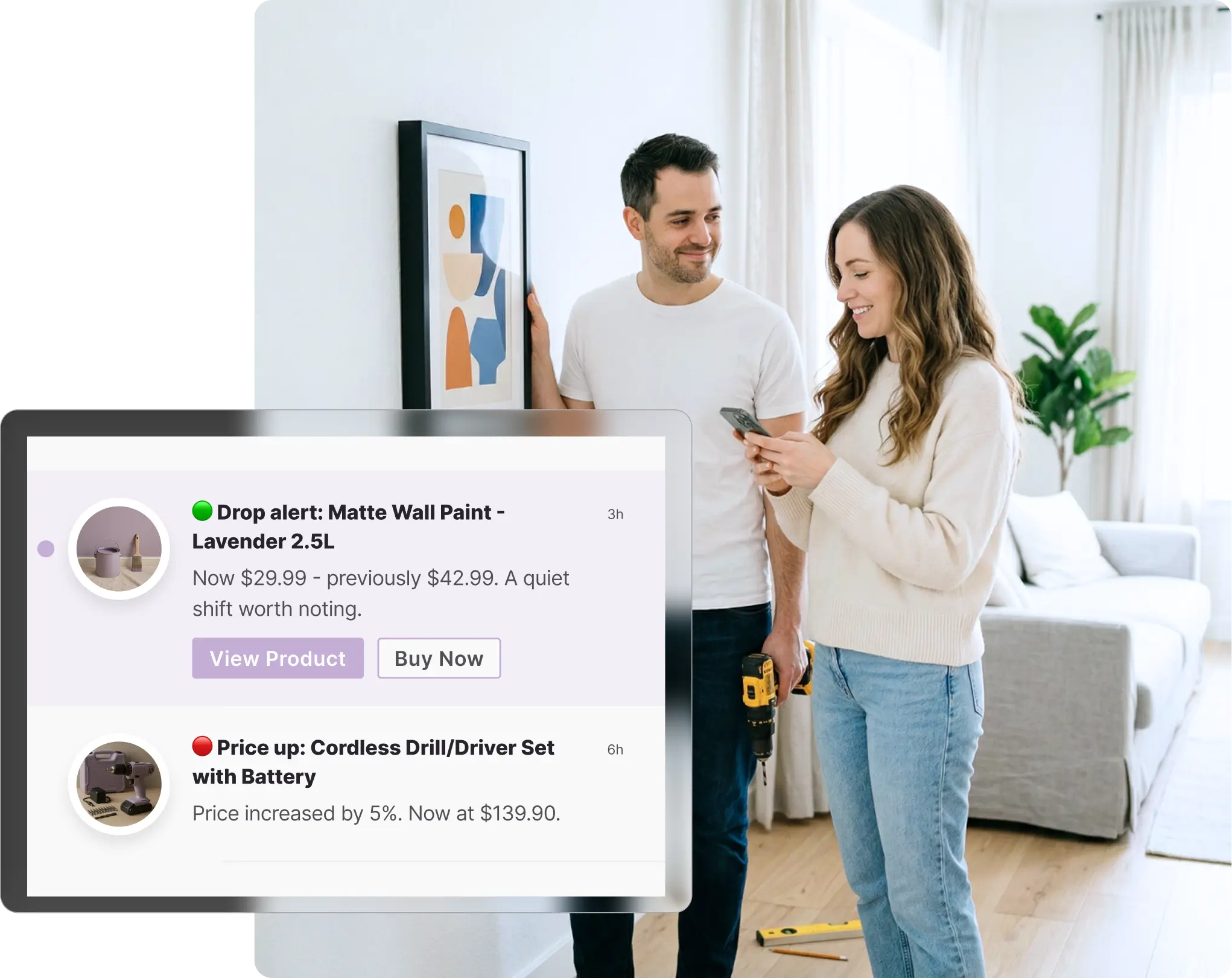 Couple hanging a picture frame on a wall at home, with the woman checking her phone, viewing Bunnings price change notifications on Whisprice showing a paint drop and a drill price increase, with a power drill visible on the floor.