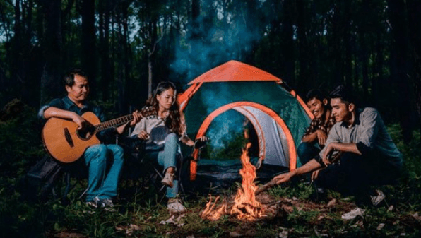 <img src="your-image.jpg" alt="A group sitting around a bonfire, enjoying music and warmth under the night sky." />
