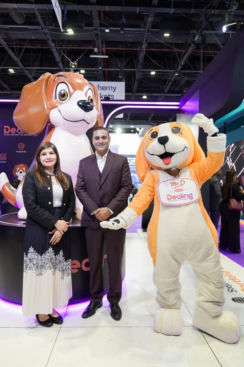 Two women posing with event mascots