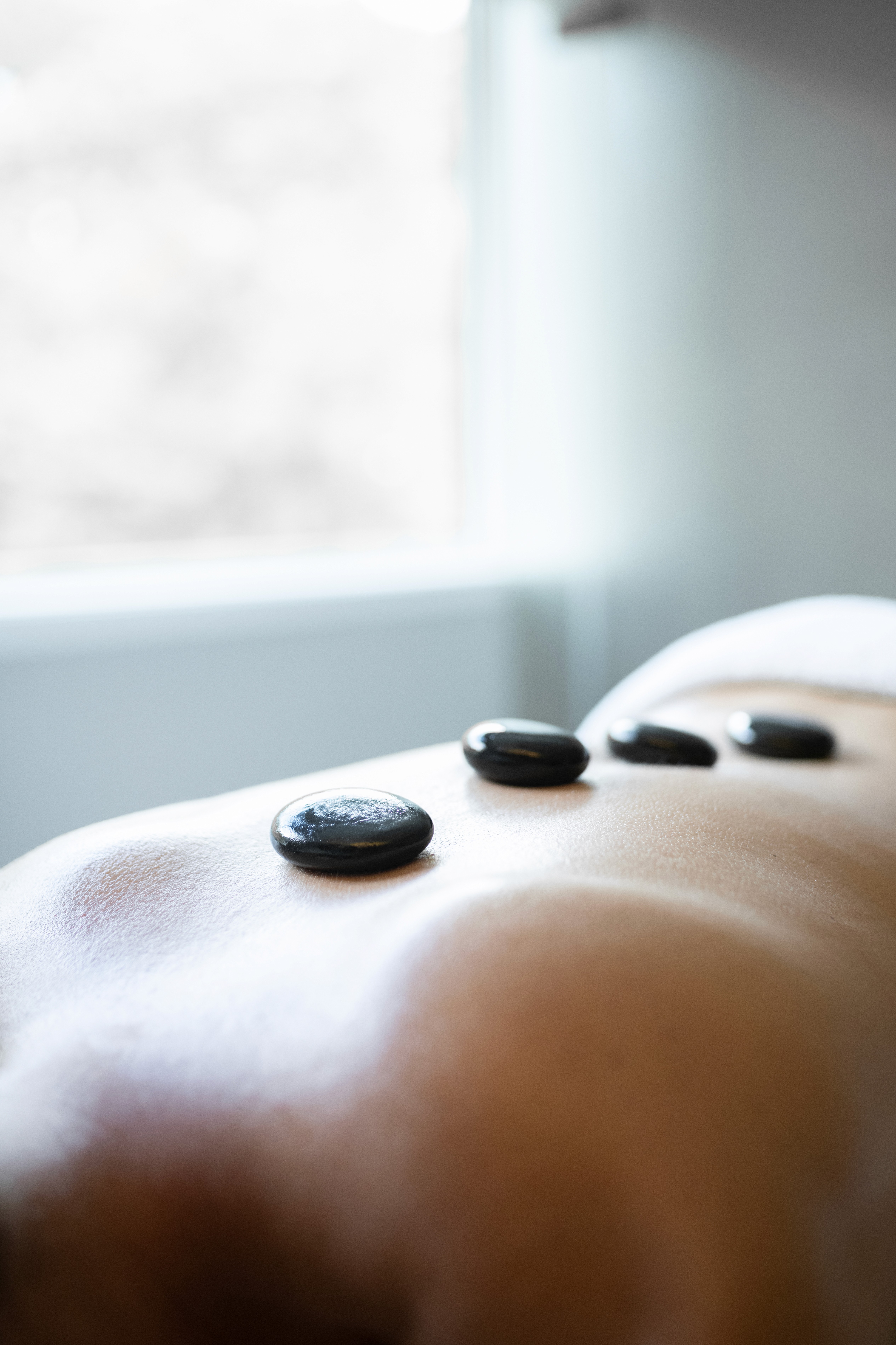 A sumptuous buffet spread features a variety of dishes including a bowl of sweet potato salad with feta and seeds, a mixed green salad with croutons, thinly sliced cured meats presented elegantly, and a vibrant antipasto platter adorned with arugula and sliced peaches.