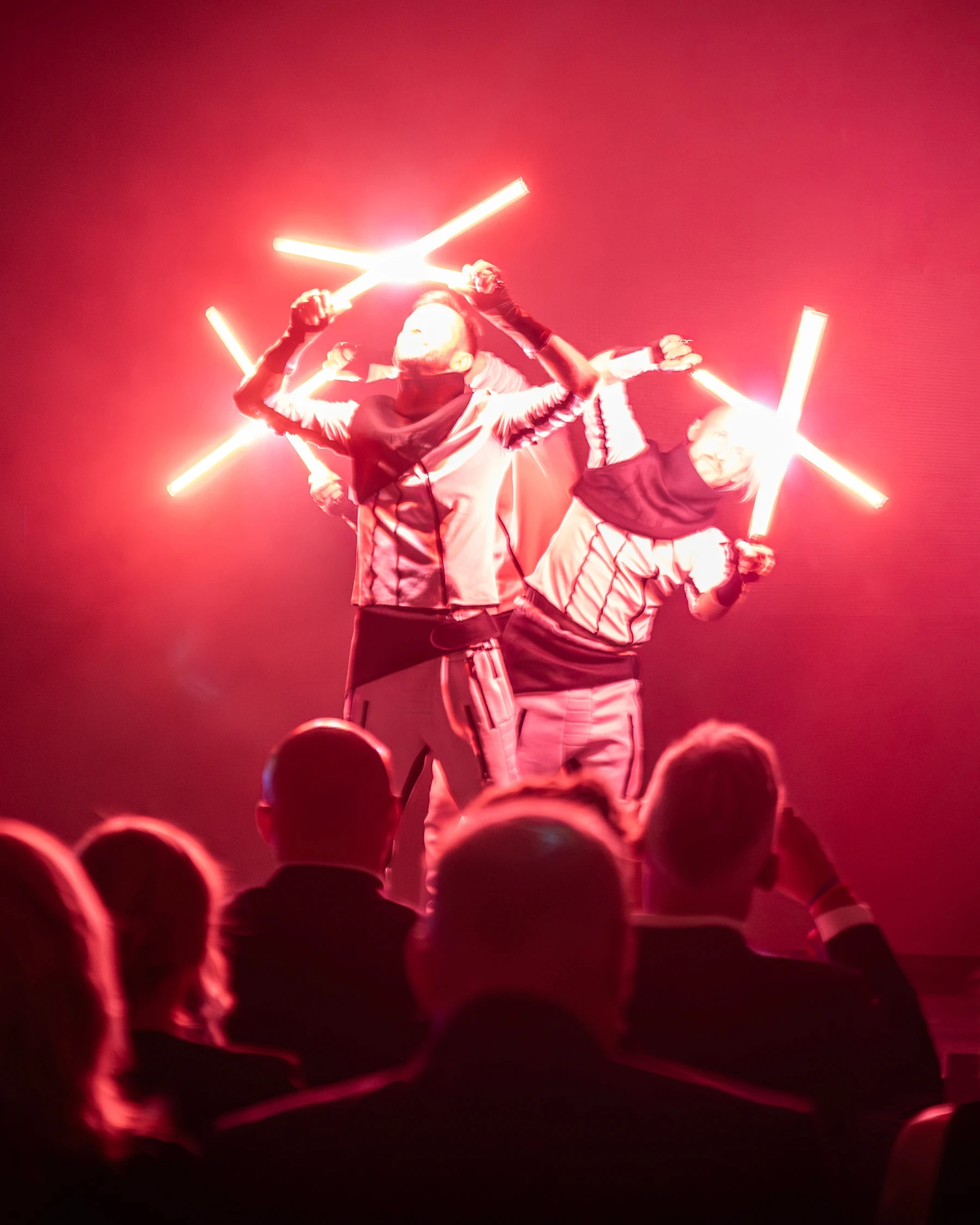 Artists with lasers, red background and red lasers