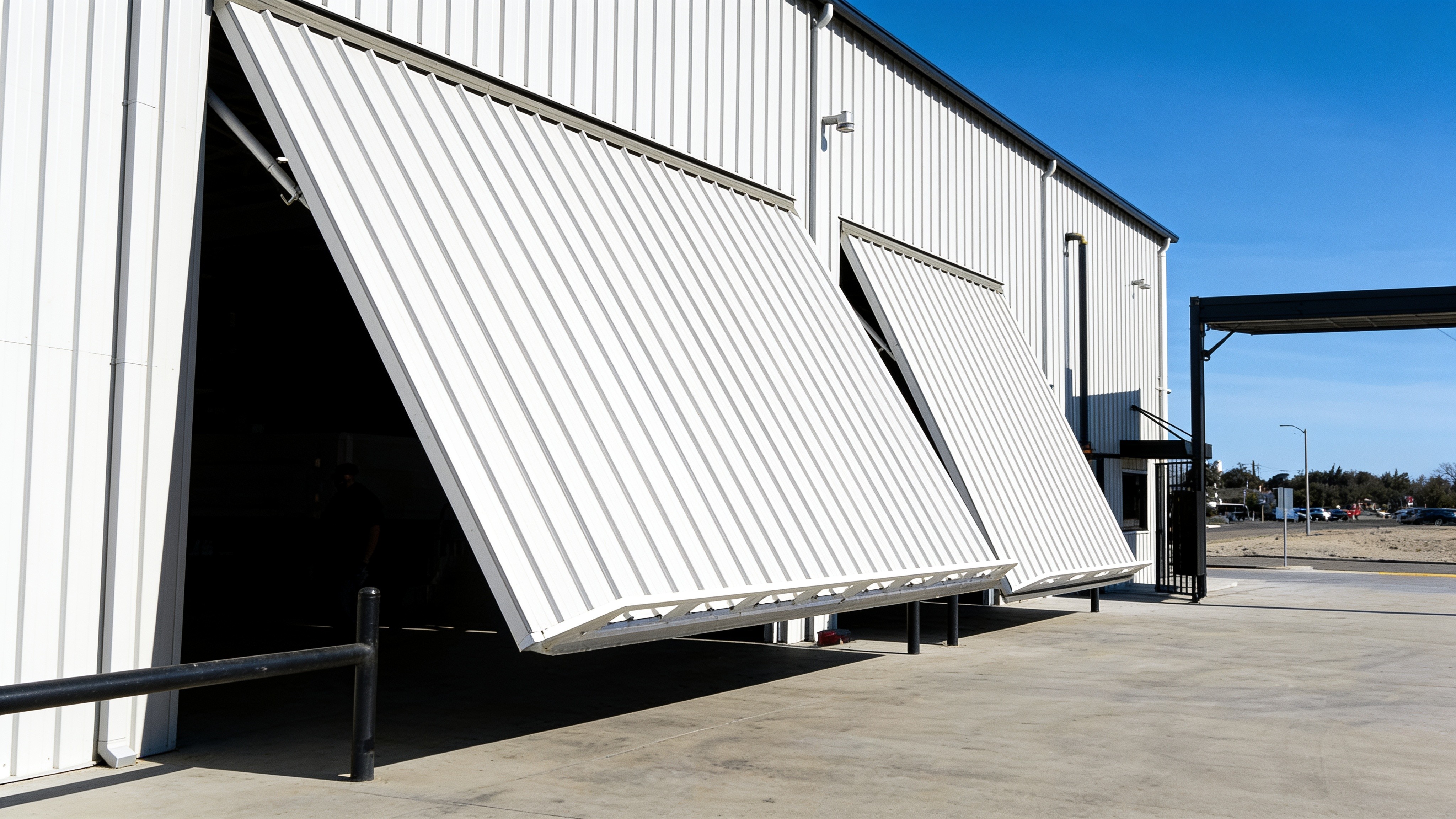 Metal office complex with an open hydraulic service bay door