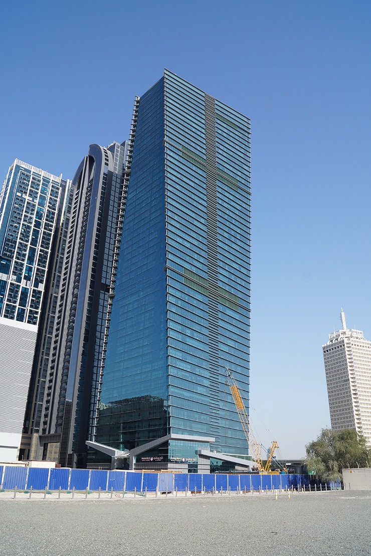 Wide shot of Sama Tower highlighting available real estate opportunities in a thriving urban district.