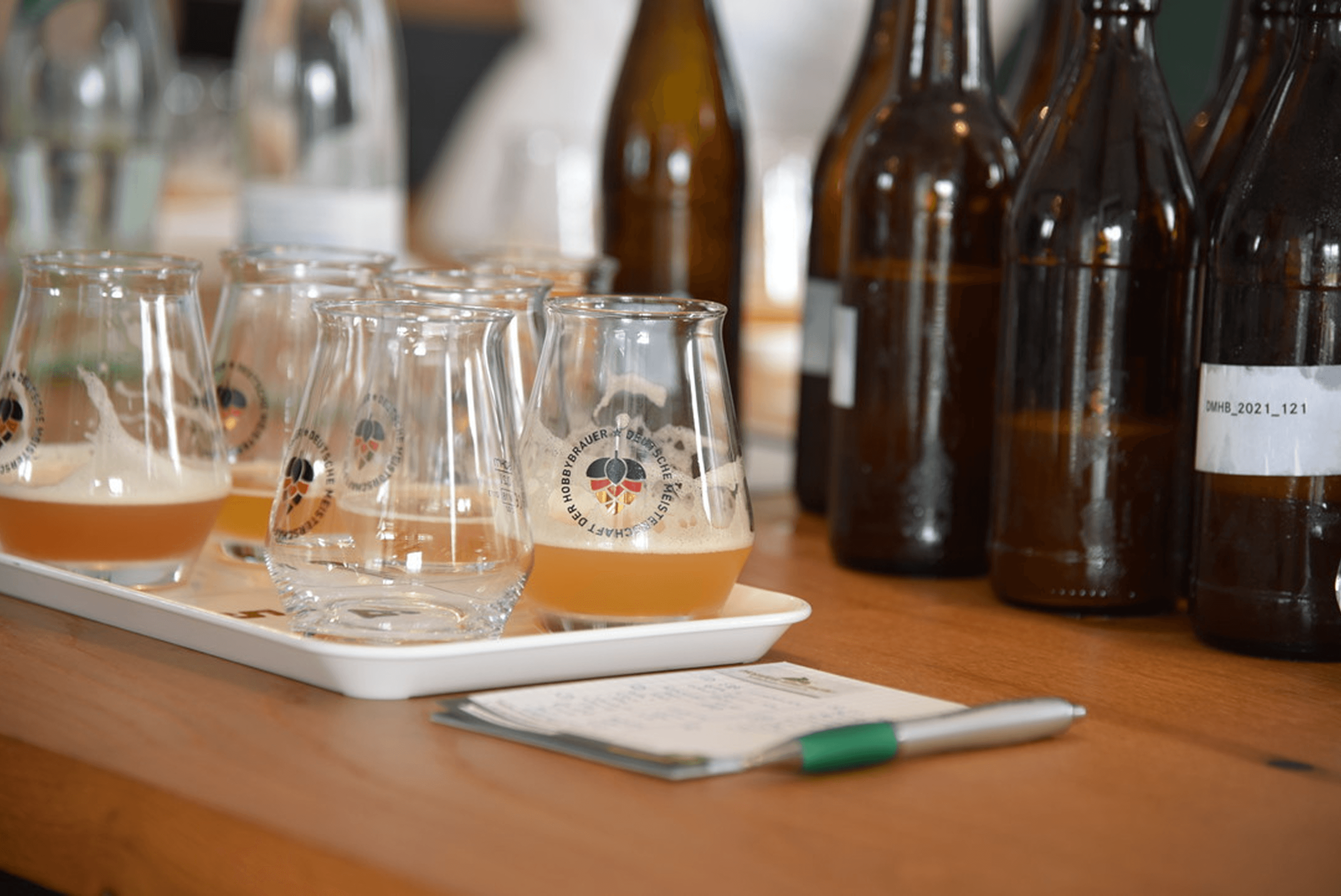 Beer tasting glasses with brown bottles
