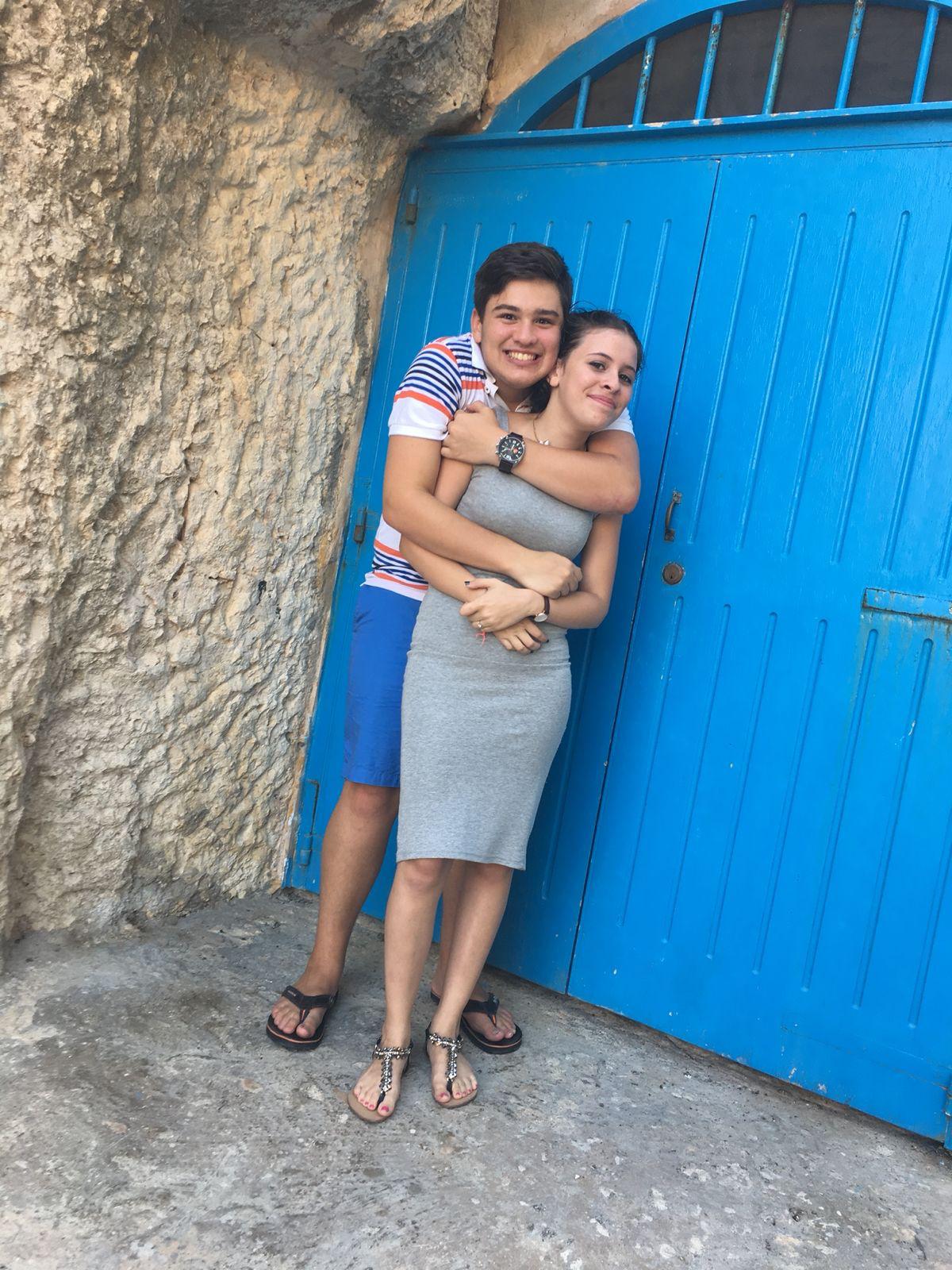 Two gold wedding rings rest atop a soft, textured fabric with a subtle pattern. The rings shine under gentle light, evoking themes of love and commitment.