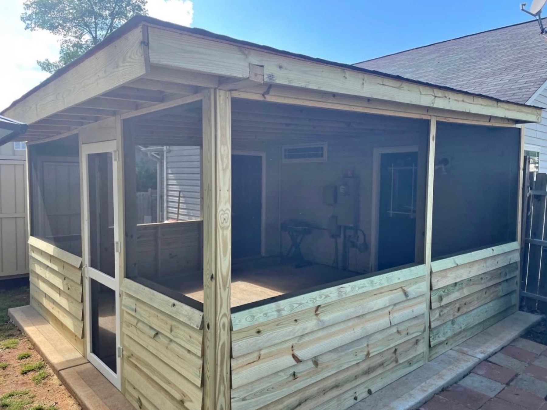 Screened porch with a screen door and lower wood siding