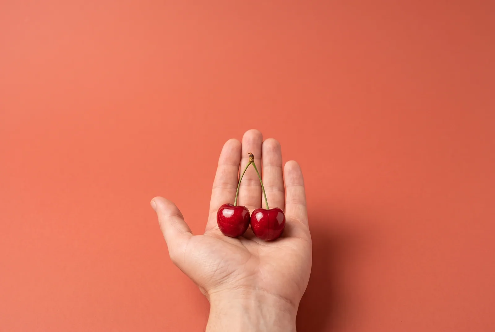 Free Fortify alternative concept: an open palm offering two cherries joined on one stem