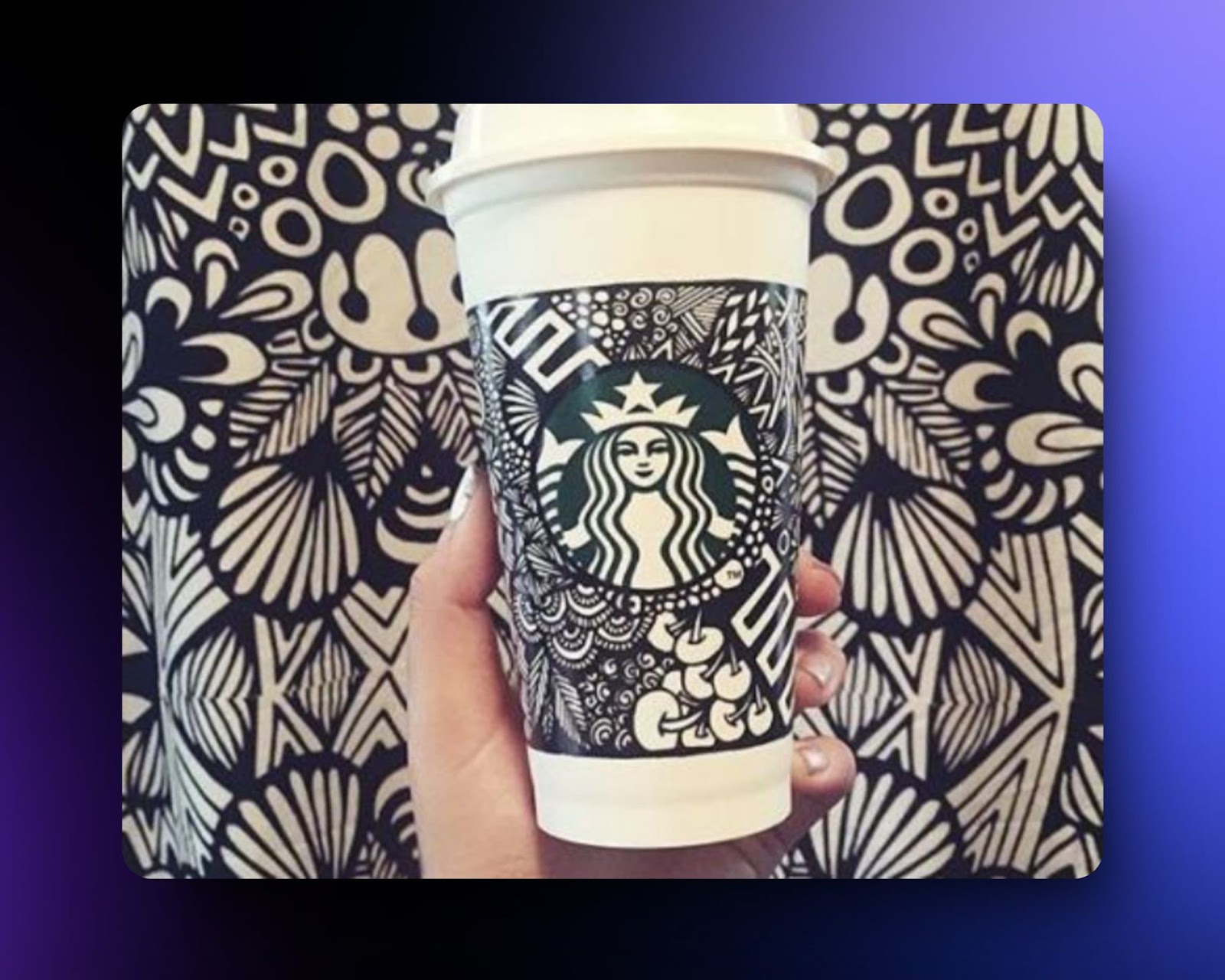 image of Starbucks cup with intricate black-and-white doodles, blending art with branding, creating a unique and visually appealing design.