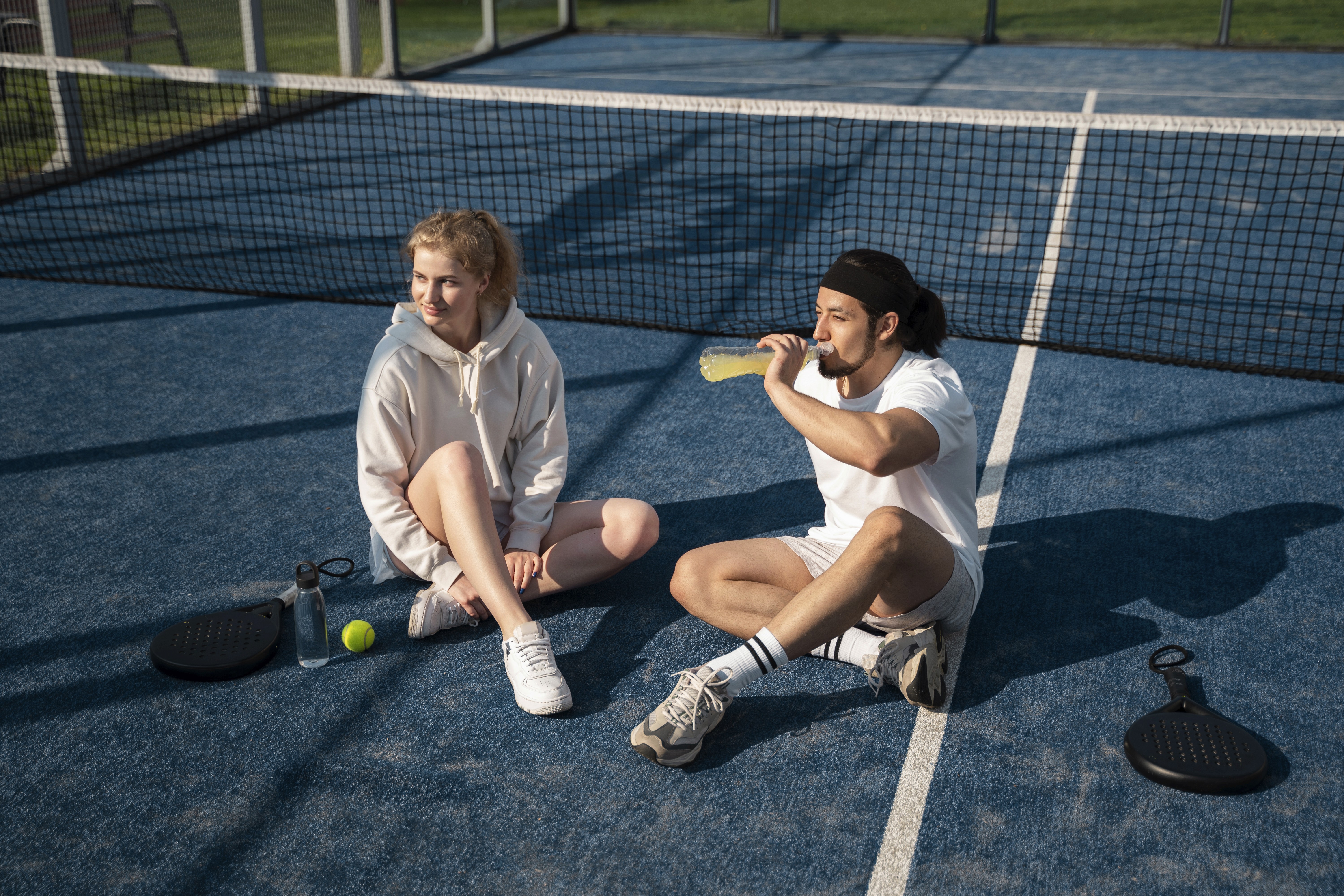 A talent recruiter with a soft smile working on her laptop in the office. The angle is on her face so we can't see what's is on the screen. She is wearing a blazer 