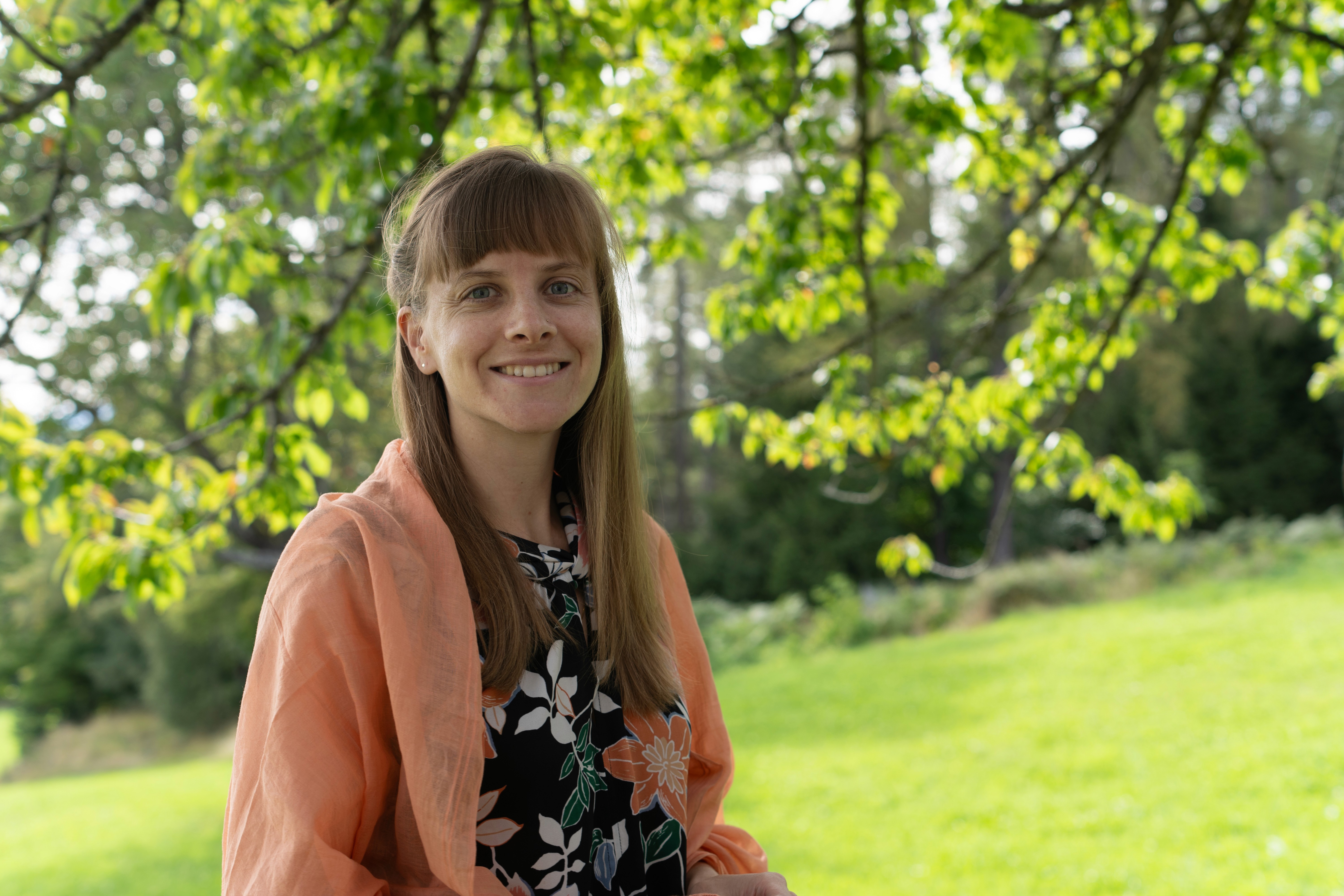 smiling girl in blue sleeveless dress