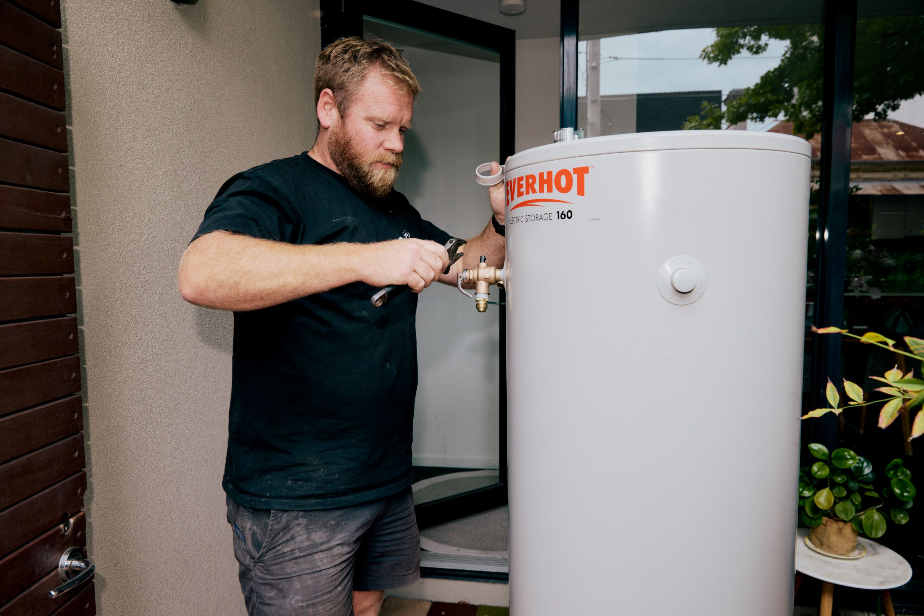 Good Maintenance Plumber fixing an Everhot hot water system.