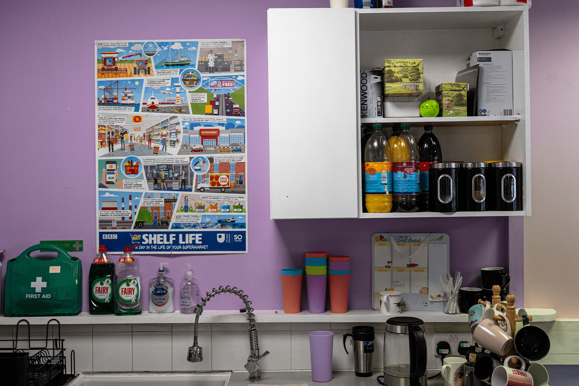 Interior of a café showing a neatly arranged shelf with glasses and cups meticulously organized