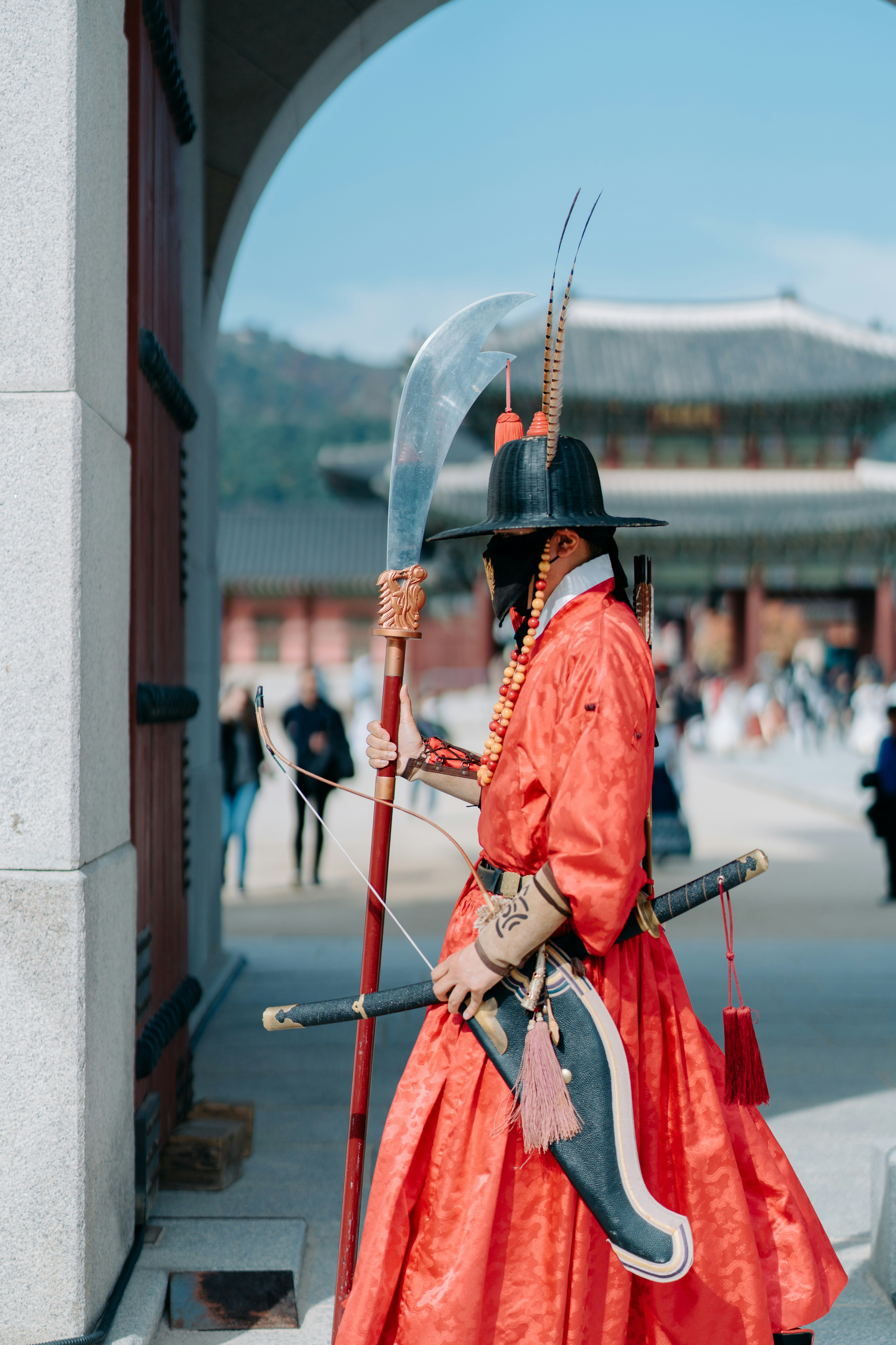 a man dressed in traditional wear holding a sword