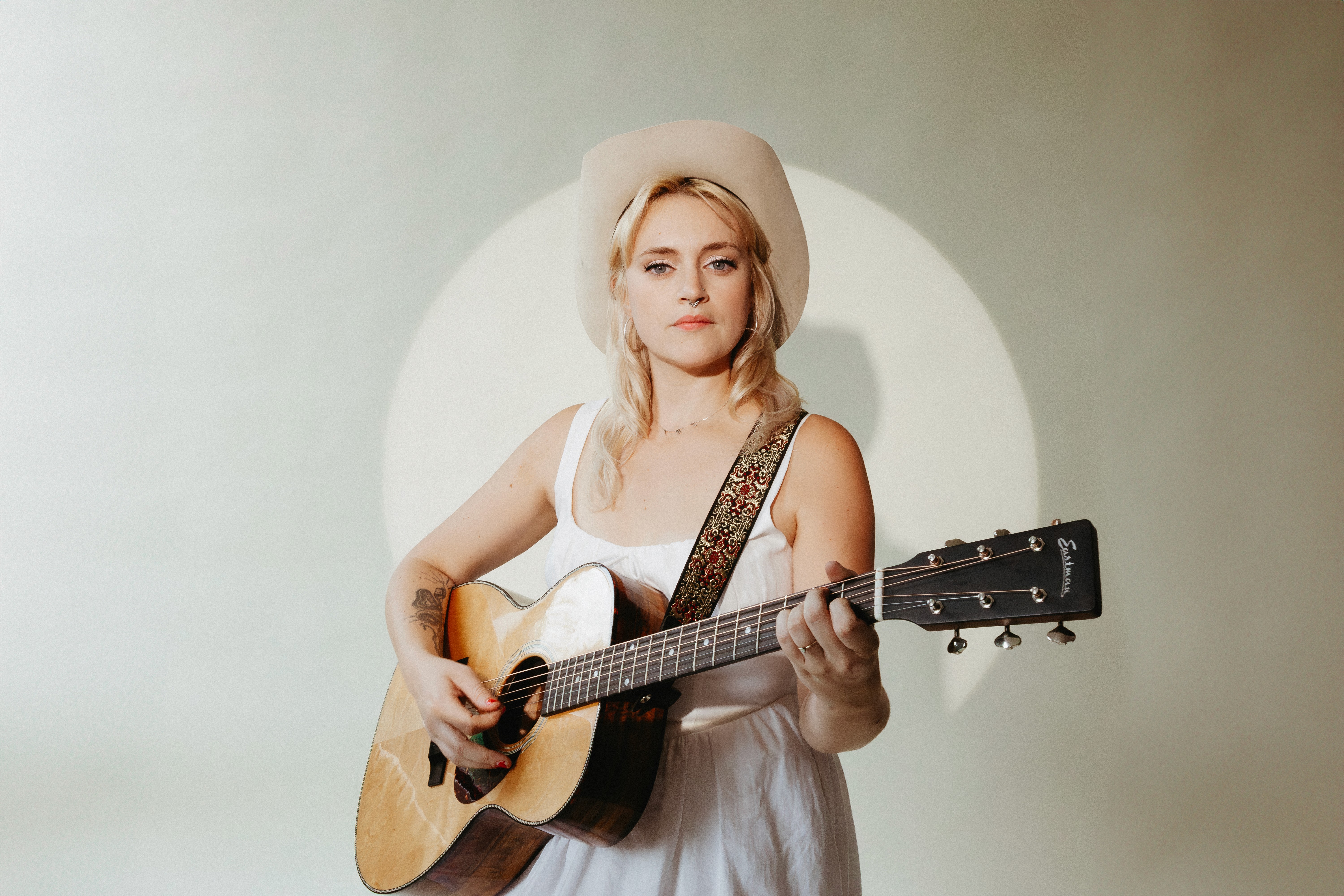 Portait of music artist Guinevere Goodwin in a spotlight against a natural background