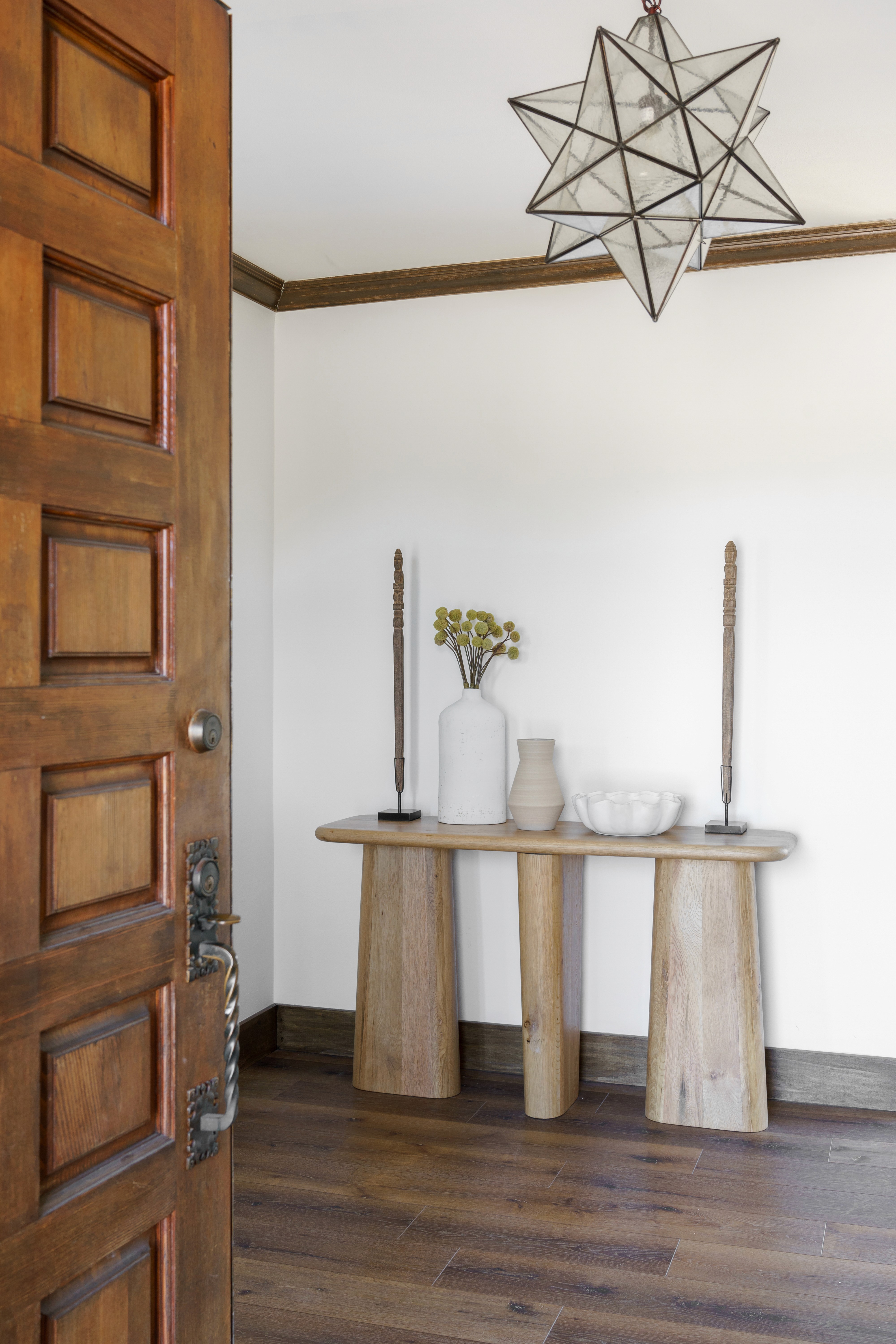 Stacked brick staircase ascending to an elegant glass door entry