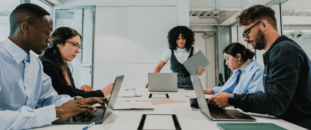 Coworkers together at a team room table