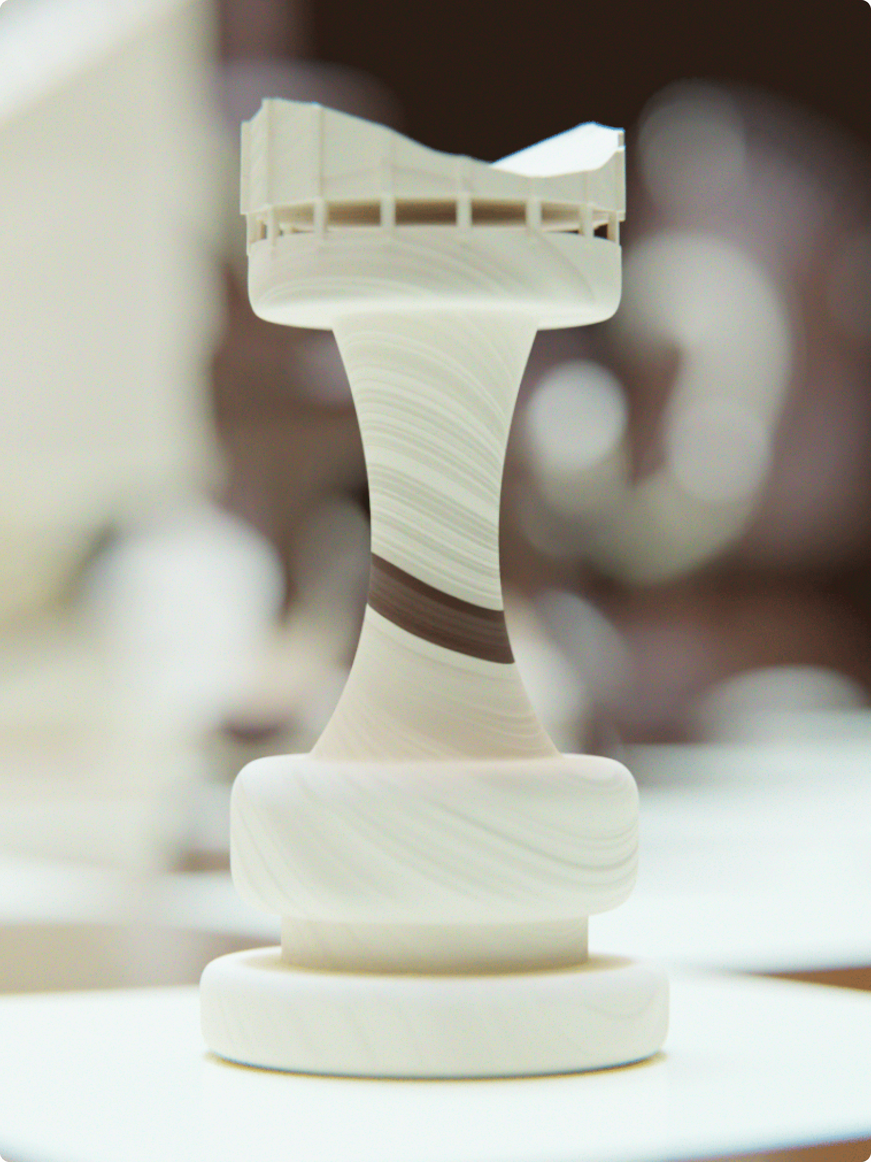 Beige canvas tote bag draped on a stone bench, printed diagonally in black with the stacked words “AVANT GALLERY”.