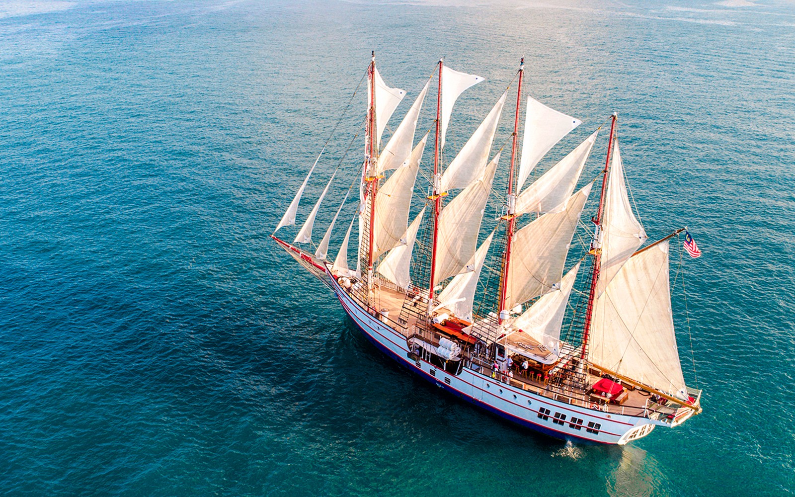 The Royal Albatross docked at Marina Bay, Singapore, showcasing its majestic sails.
