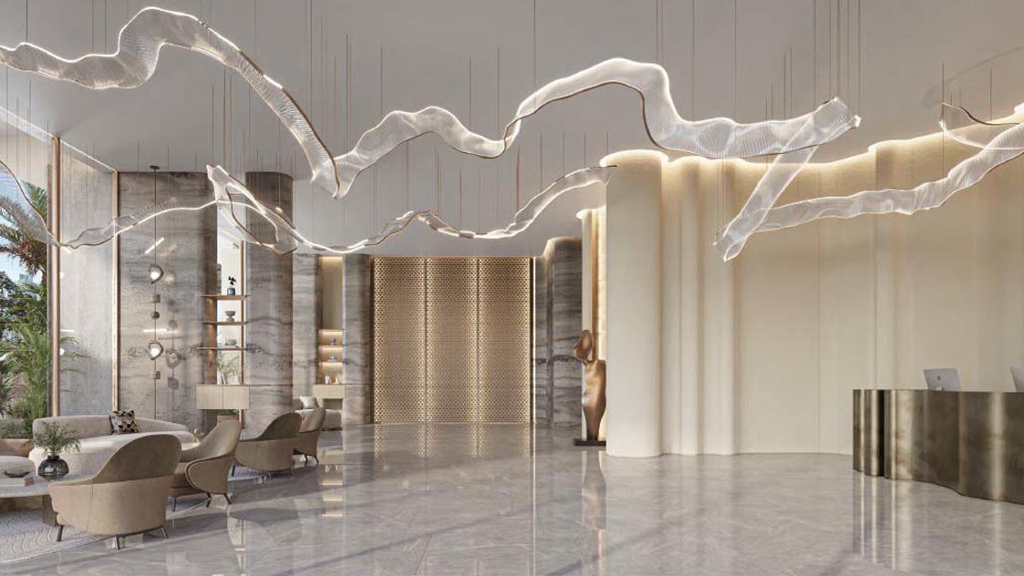 The Caden by Prescott lobby showcasing a grand chandelier above a sizable table.