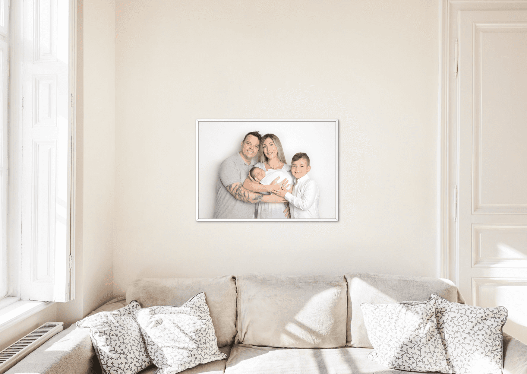 A warm and happy family photoshoot frame hangs on the wall, captured in a creative family photography in Dubai by Mahvin.