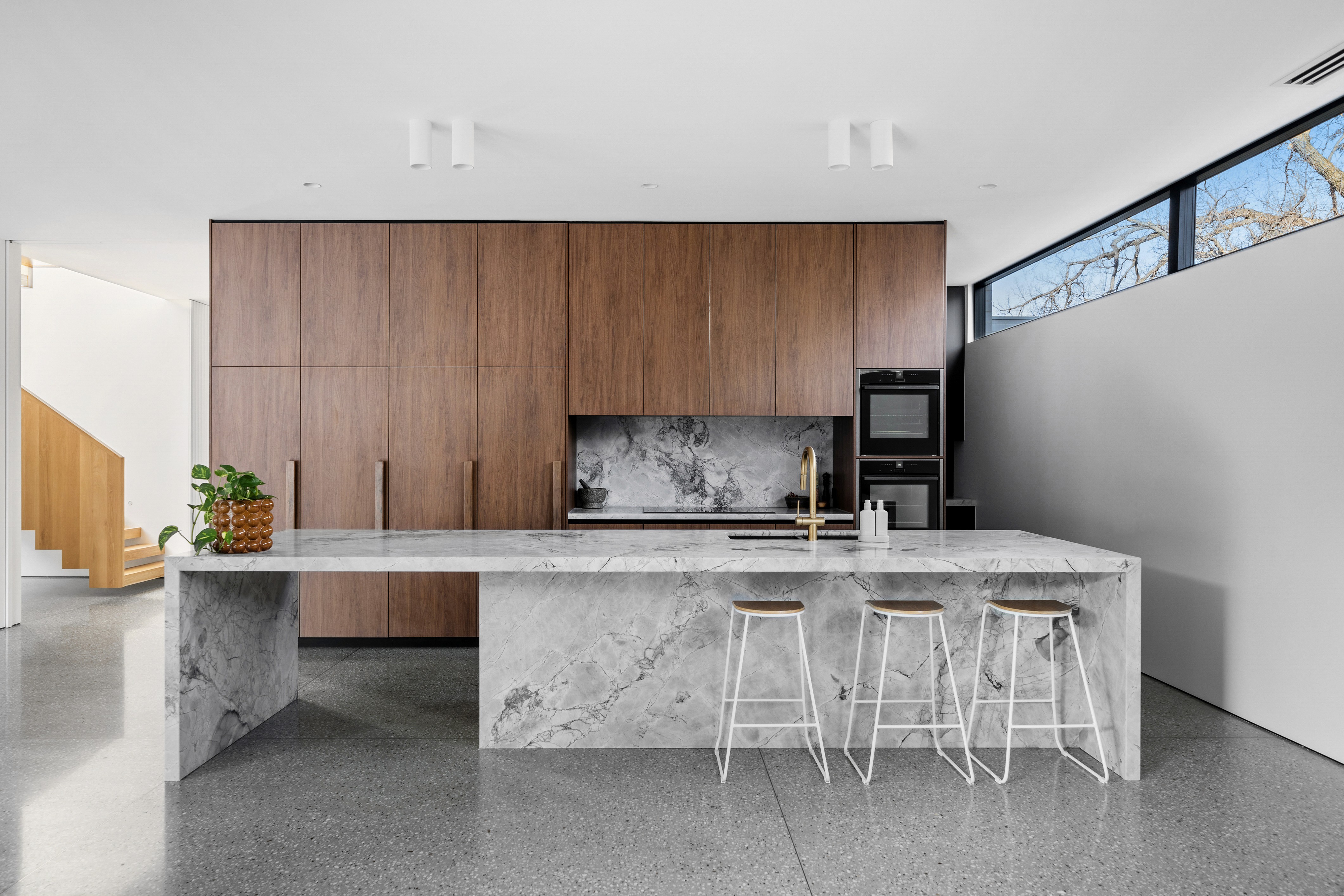 Man on beach with palm trees and mountain