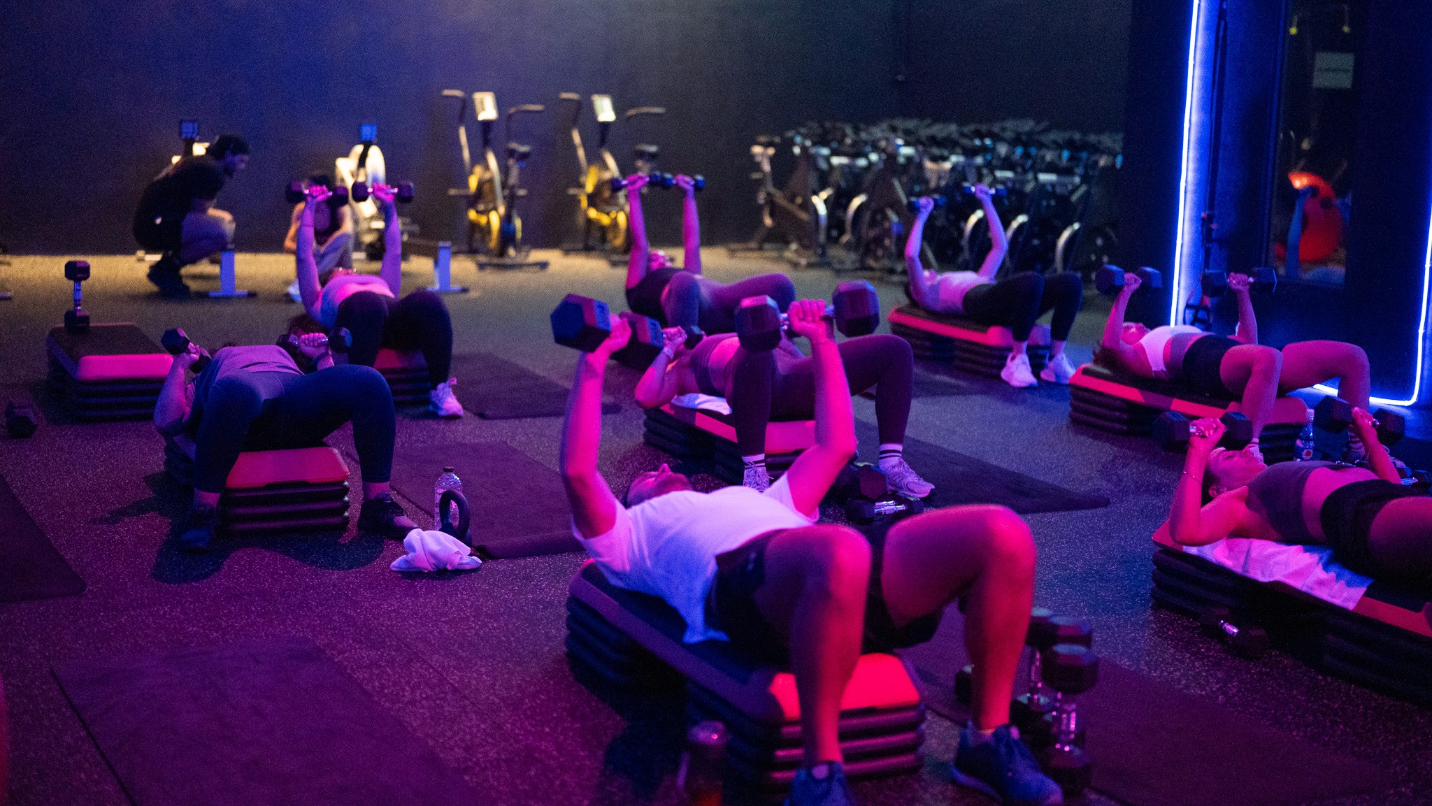 Dynamic group fitness session at Legacy Muscle Universe Koh Samui, featuring high-intensity Zumba and spin classes in a vibrant, motivating studio.