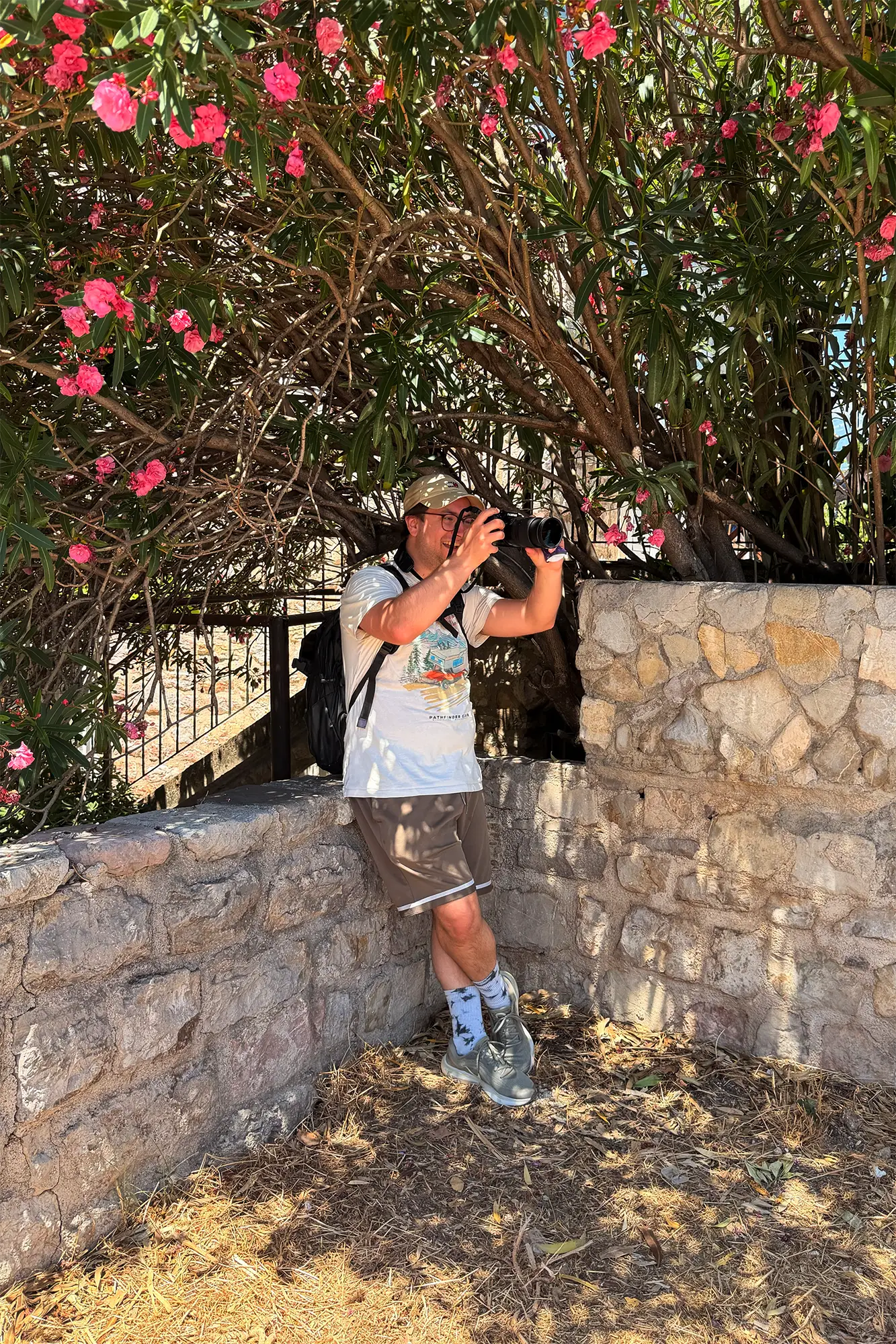 ?artin Paseka taking photos under tree