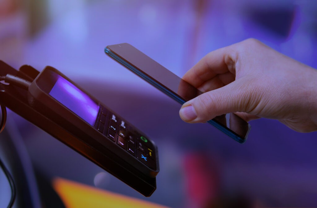 Person using their mobile device to make a touch free payment