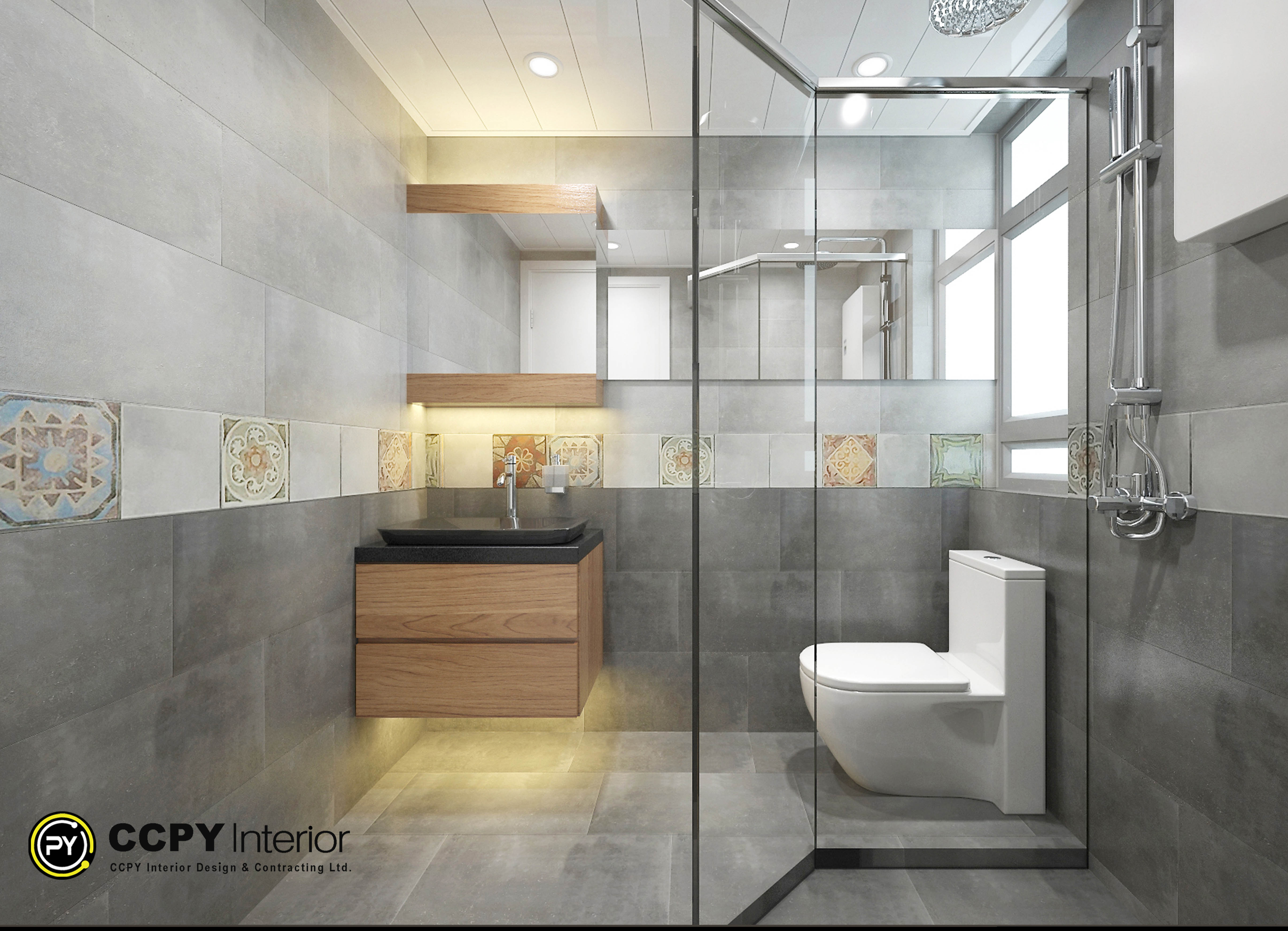 The selected region displays a modern, fully renovated bathroom design featuring a balanced mix of neutral gray tones and warm wood accents.Visual Elements & LayoutWall Tiling: The walls are covered in horizontal, large-format gray tiles with a matte finish. A decorative accent band features patterned, square tiles with vintage and geometric motifs running across the middle of the wall.Vanity Area: A floating dark wood vanity unit sits under a rectangular mirror. It is paired with an understated black countertop or basin. Two floating wooden shelves are mounted vertically next to the mirror for storage or display.Toilet: A modern, white, floor-mounted toilet with a geometric, block-style cistern is positioned next to the vanity.Shower Area: A frameless glass partition separates the wet shower zone from the dry toilet area. Vertical stainless steel shower fixtures and a chrome towel rail are mounted on the right wall.Lighting: Bright, natural light flows in from a large frosted window, supplemented by soft, warm under-cabinet or recessed lighting that highlights the floor area.